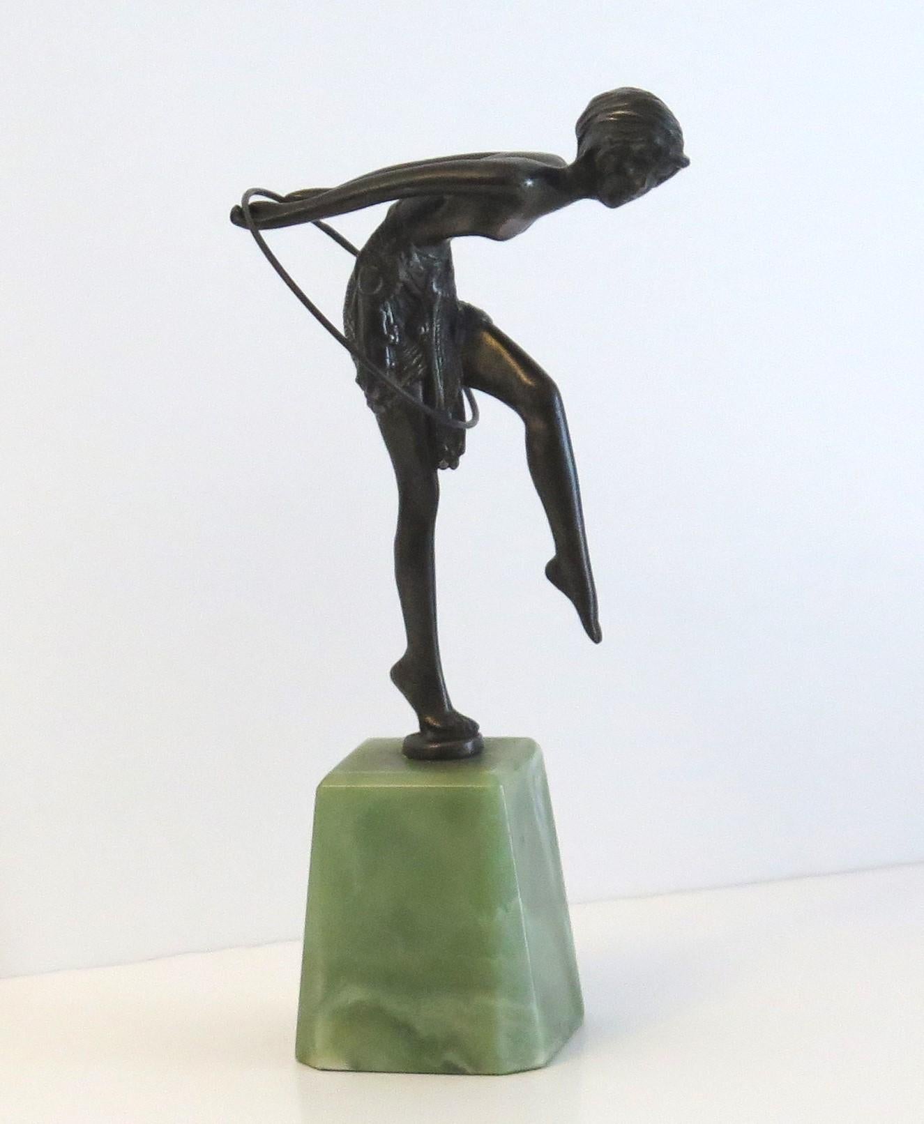 This is a solid bronze figurine of a dancing lady called Hoop Girl after D H Chiparus, on an Onyx base, dating to the Art Deco period, Circa 1925 to 1935.

The figure is beautifully sculpted in very good detail- see the skirt and feet.

The