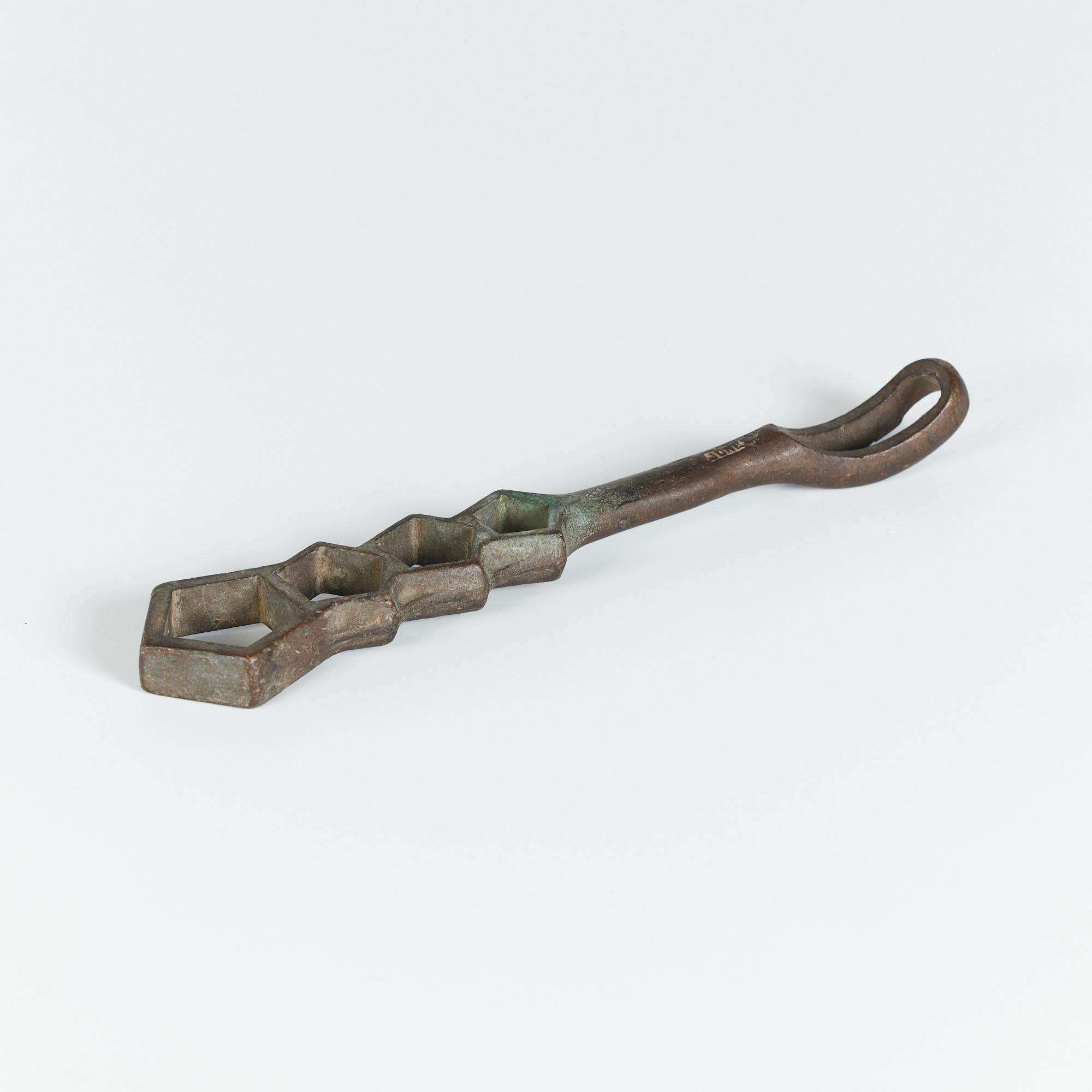 Cast bronze five hole fire hydrant wrench by Jones, USA. This piece can used for its original intention or for decorative purposes. Due to its weight it would be a perfect office paper weight. Any fan of abstract sculptural works will truly enjoy
