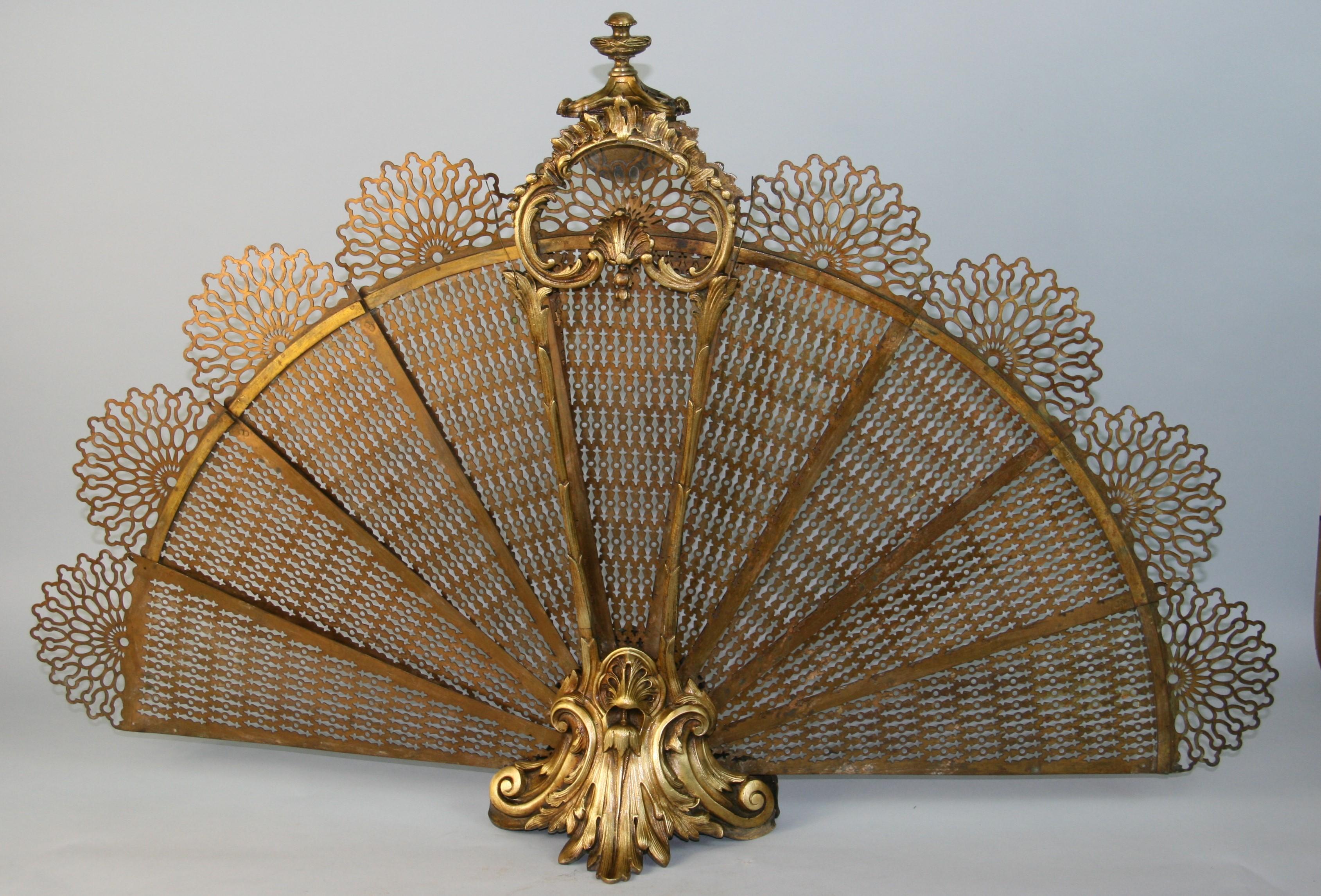 1380 French  brass pierced gallery urn finial acanthus foliage folding fire place fan screewith decorative centered cat tail and shell motif late 19 Century. 
Open dimensions 25.5 x 40 x 9.5