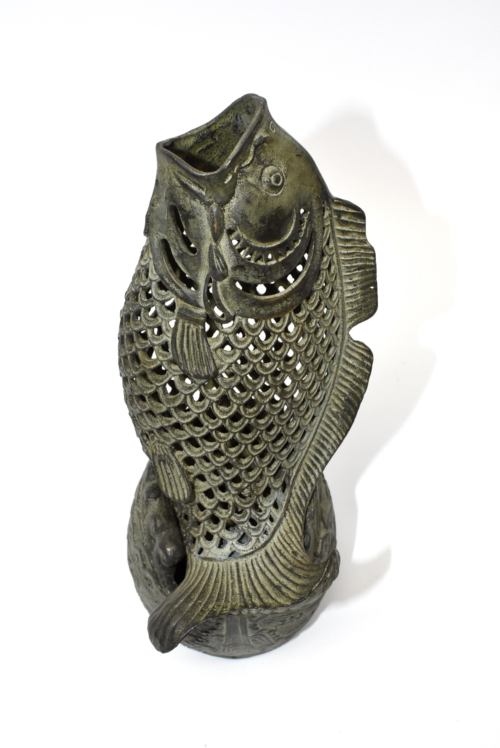 Super unique bronze fish incense burner is a delightful object the fish is the famed and prized oriental carp, which is symbol of prosperity and wealth. The base features waves and water pattern, which echoes the 