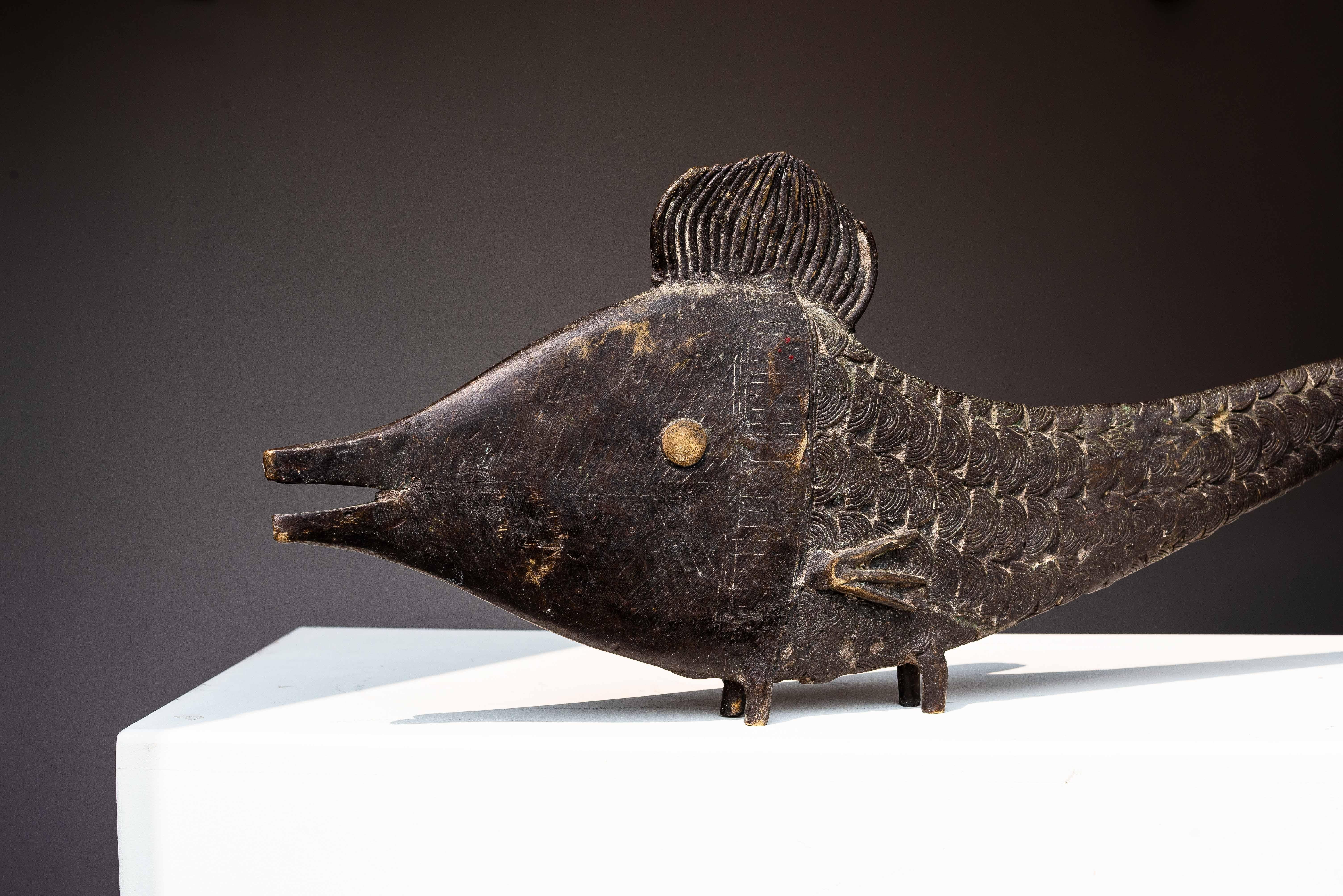 Bronze Fish Sculpture, Benin West Africa, Mid-20th Century

Large and heavy African bronze sculpture of a fish from Benin, circa 1950.

Crafted using the lost-wax technique, it features hand-incised detailing representing scales, fins, and a