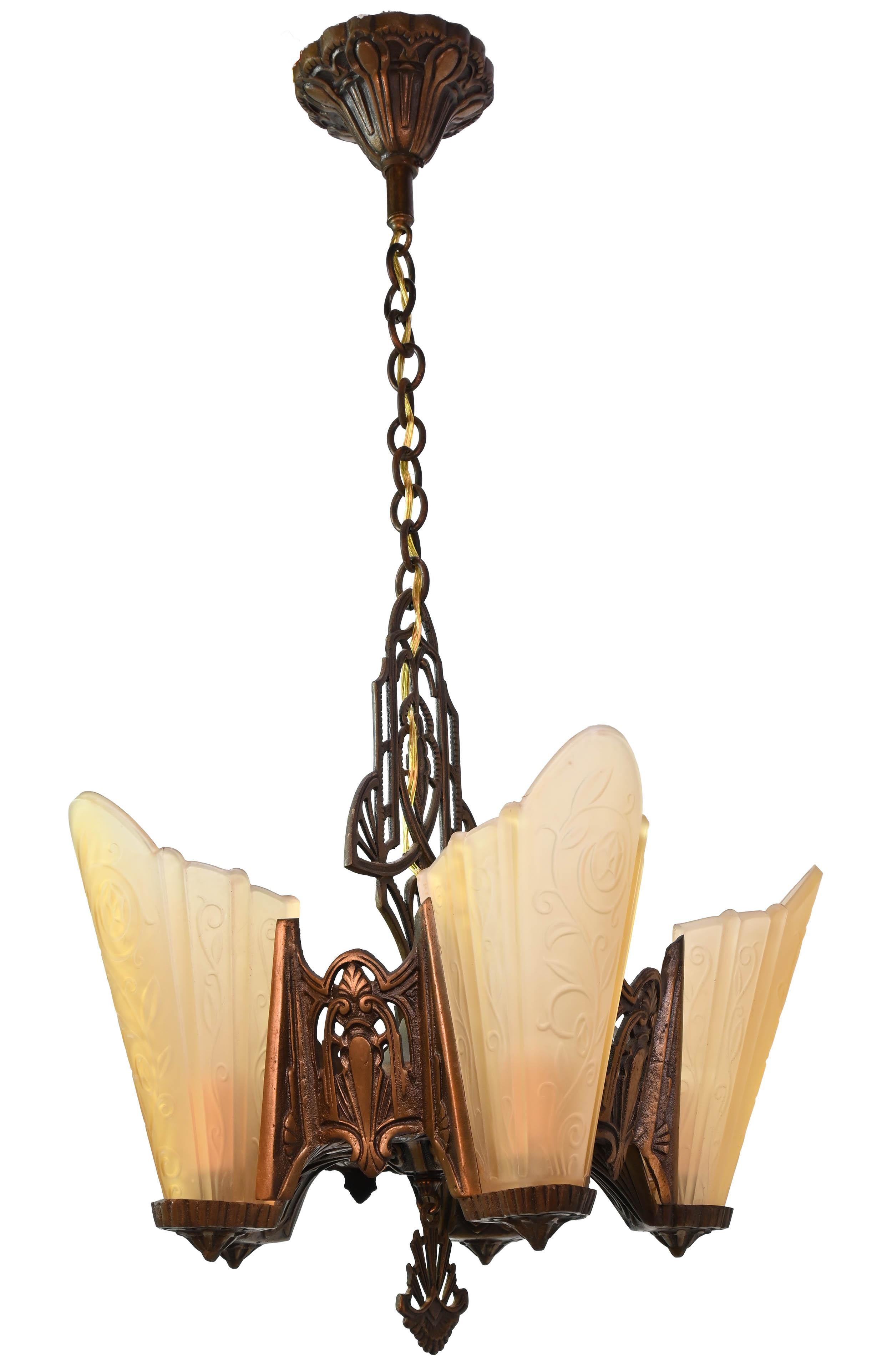 The beginning of the 20th century saw a variety of style in lighting fixtures and their detailing. Shell shaped slipper shades were commonly seen in lighting fixtures of the time. This light is a presentation piece, mixing Art Deco with curved,