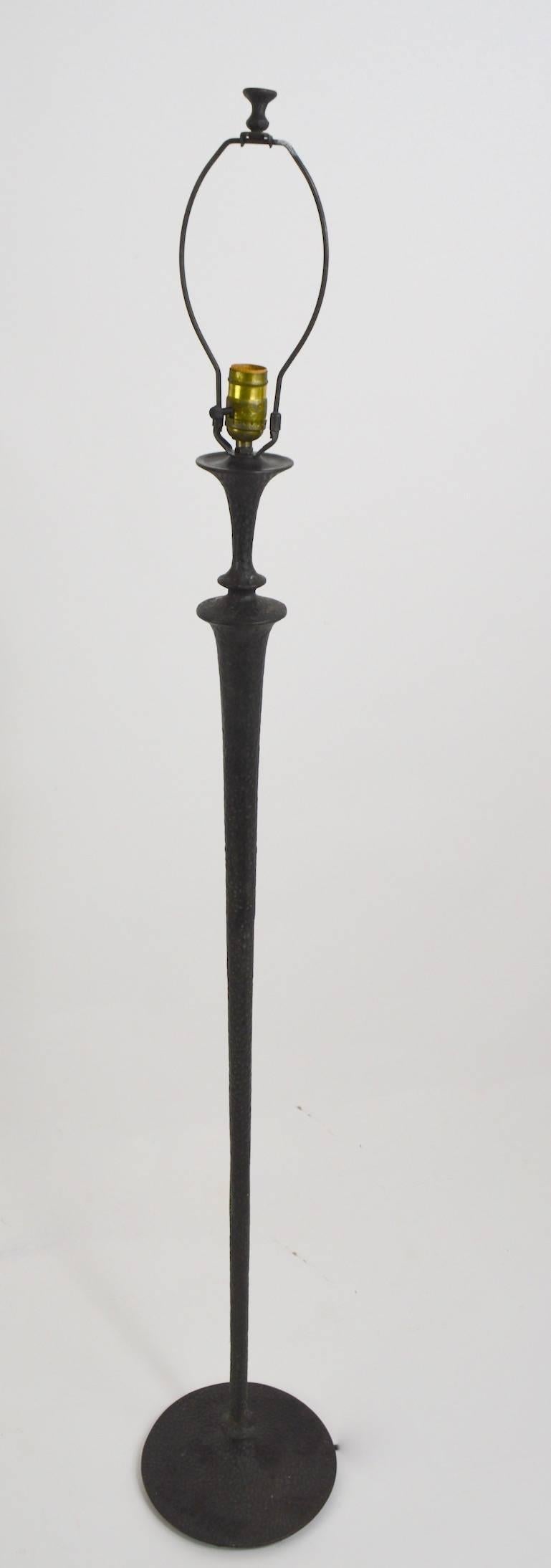 Good quality bronze floor lamp. Solid cast to a hammered surface with a darkened black finish, clean, original, working condition, shade not included. Measures: Height tom top of black base 48 inches, total H including harp 60 inches.