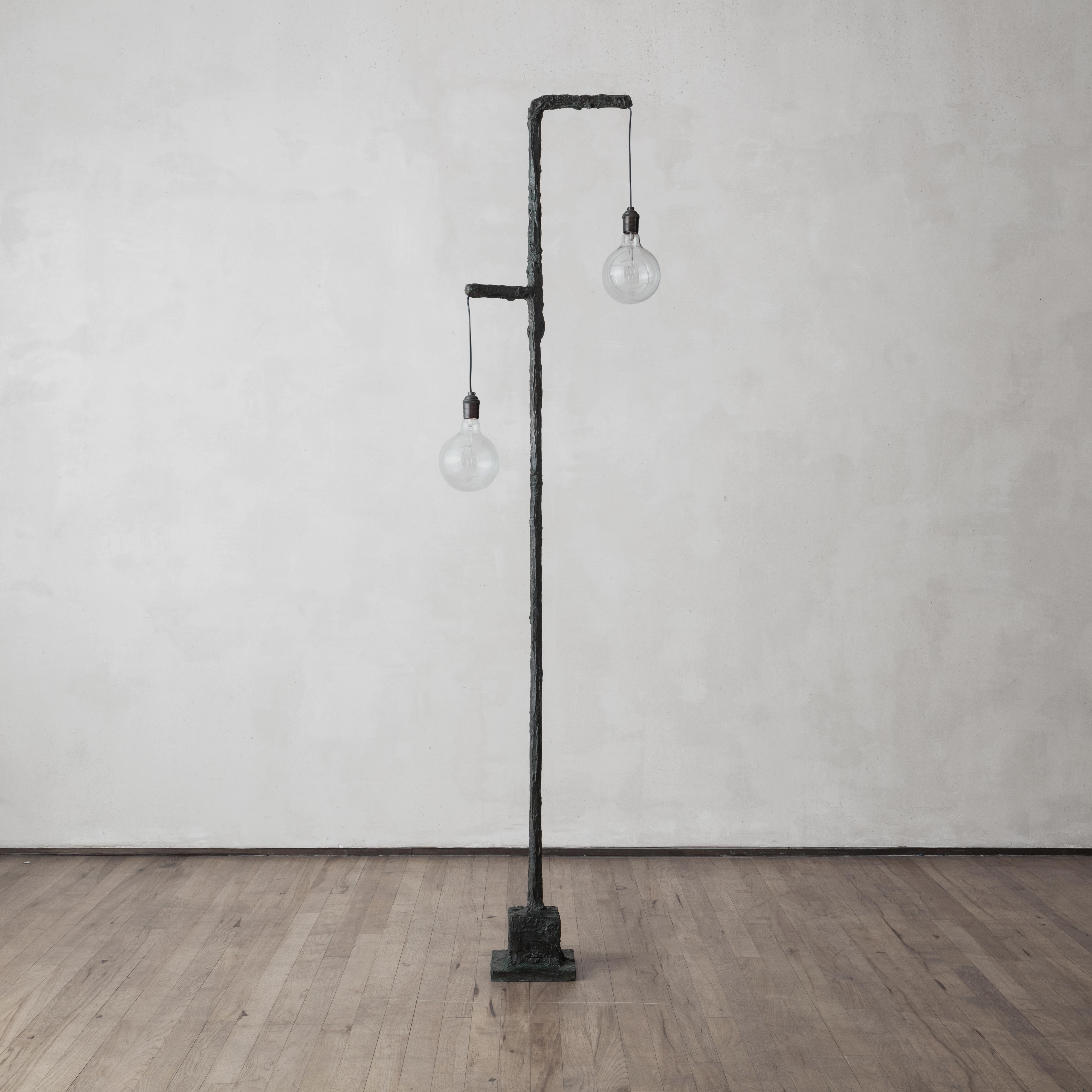 A sculptural floor lamp that finds its elegance in its simplicity. Casted in bronze, the lighting piece is a limited edition of 8 and 2 AP, is numbered and signed by the artist and casted to order in Paris.

Material: Cast bronze.