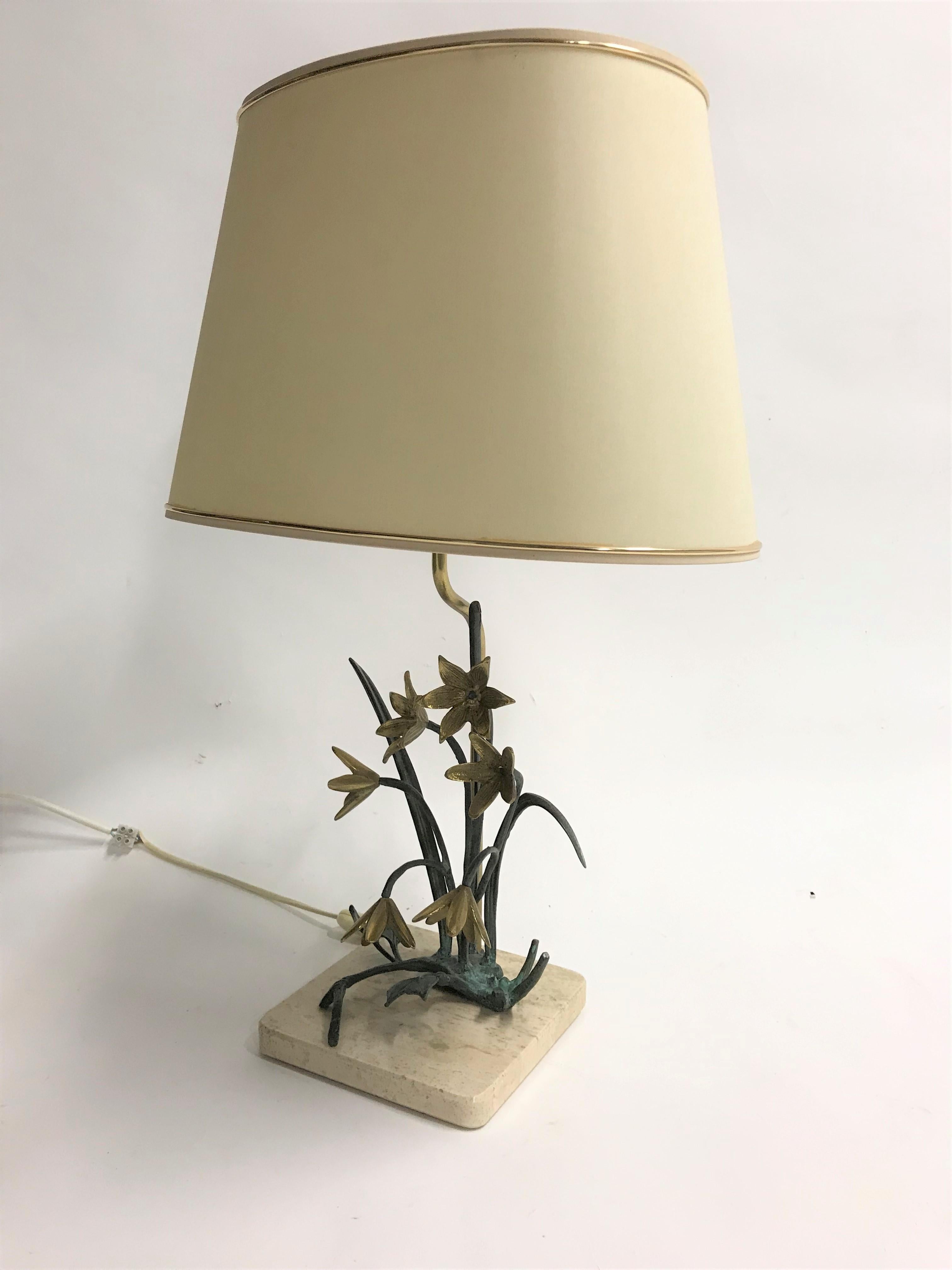 Beautiful sculptural bronze and brass flower table lamp mounted on a travertine stone base.

Well sculpted flowers and branches with eye for detail.

Tested and ready for use with a regular E26/E27 light bulb.

Comes with it's original lamp