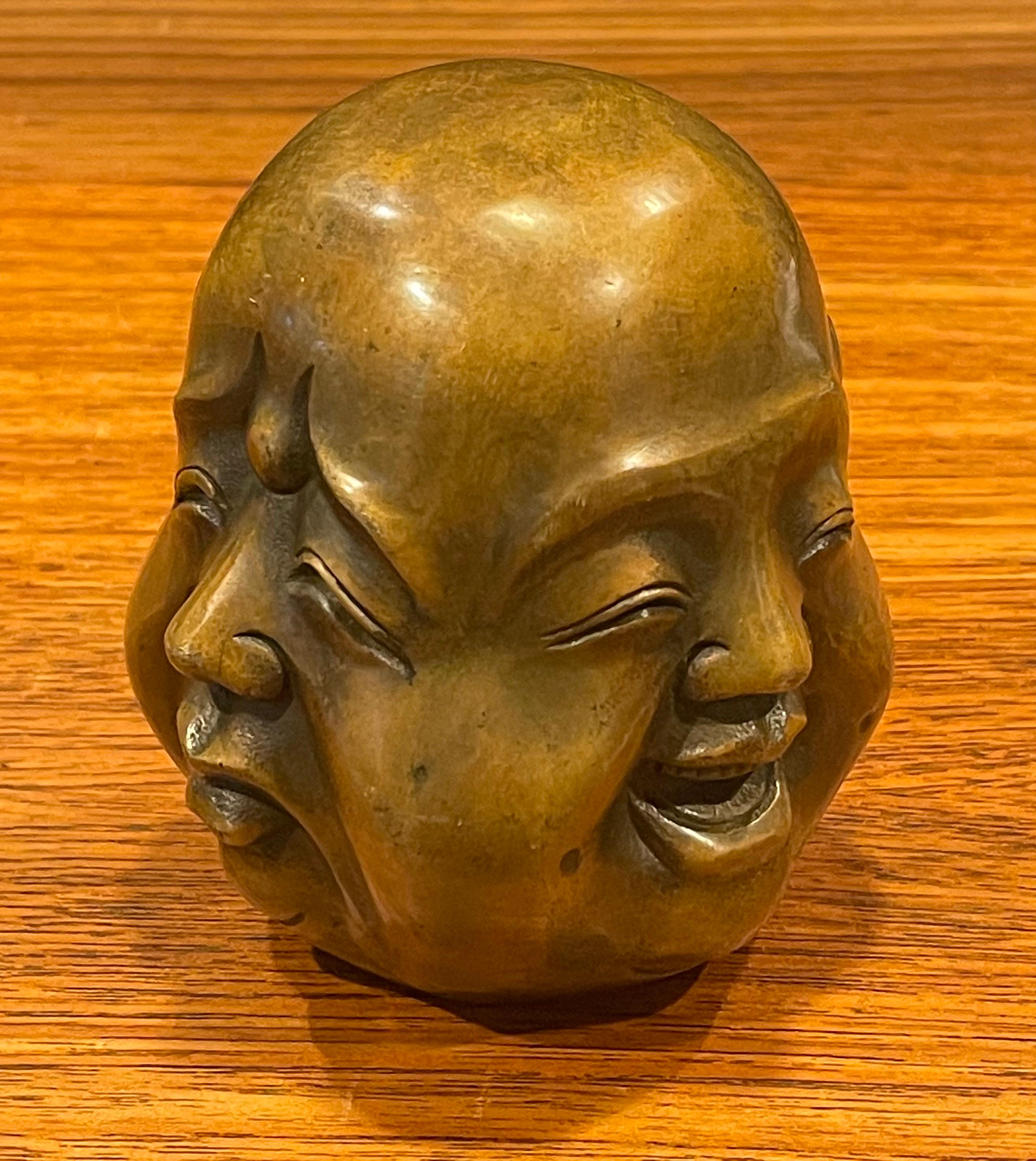 Very cool four faced bronze Buddha head sculpture or paperweight, circa 1960s. The piece is in very good vintage condition and measures: 4