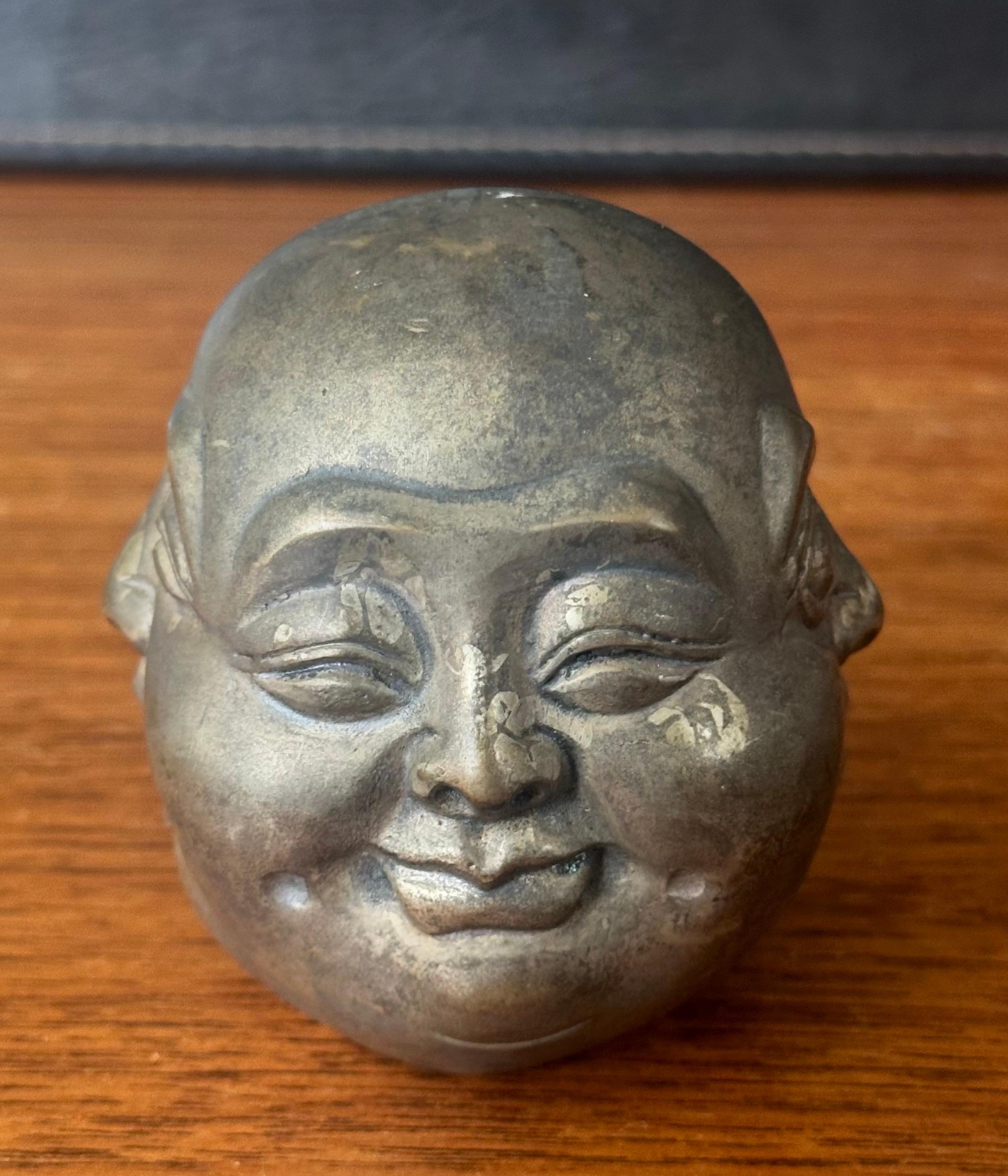 A very cool four faced bronze Buddha head sculpture or paperweight, circa 1960s. The piece is in very good vintage condition and measures: 3