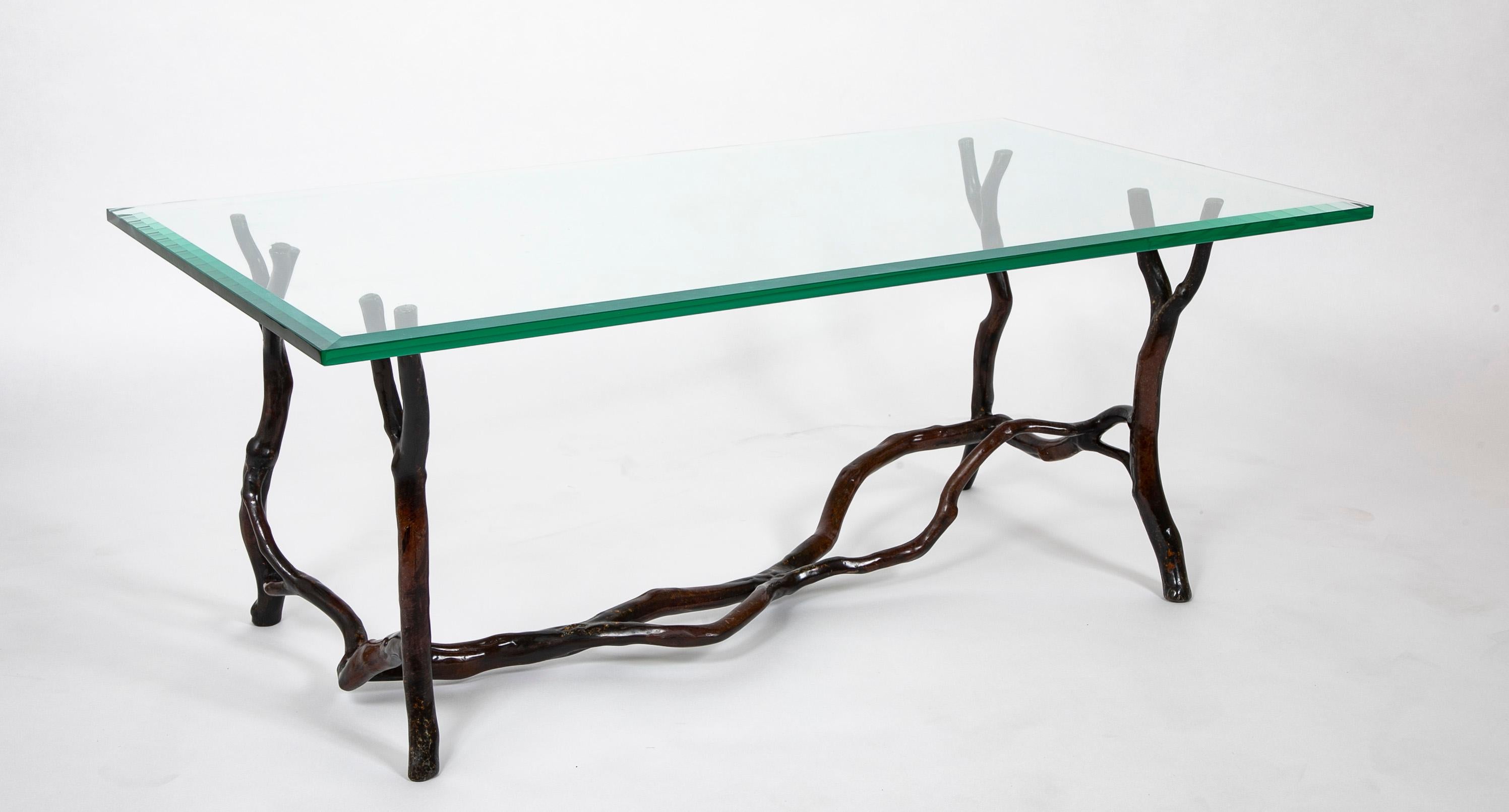 A bronze frame glass top coffee table having tree branch form attributed to American artist Carl Gillberg.
