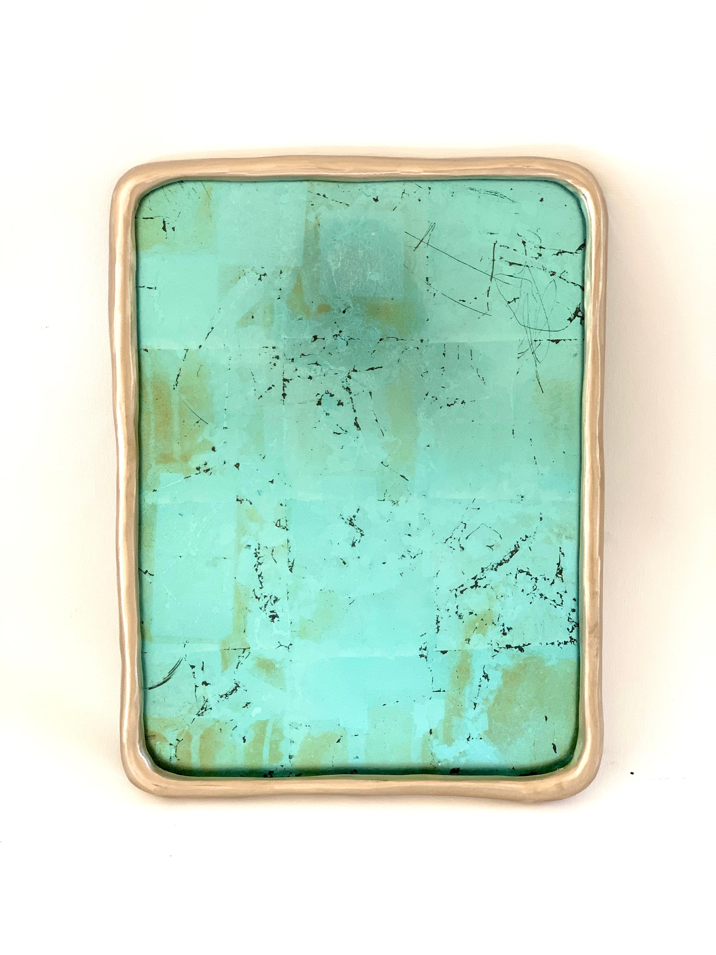 This custom crafted high polished bronze mirror frame with blue-dyed silver leaf over glass by Brooklyn based contemporary artist Alexander Kellum . The bronze body has an irregular diameter along the form creating unique reflections of light. The