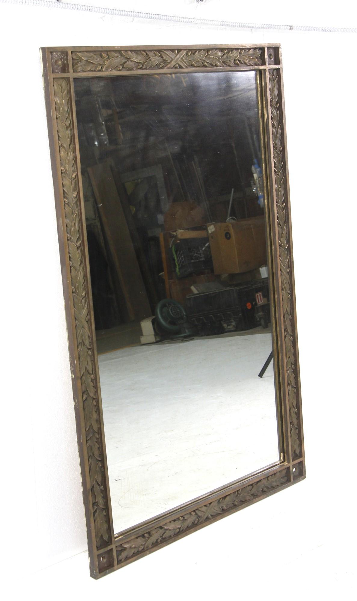 20th Century bronze framed mirror. Designed with a ornate 3D foliage pattern. A distressed mirror rounds out this antique look. Restored with a new wood backing. This can be seen at our 333 West 52nd St location in the Theater District West of