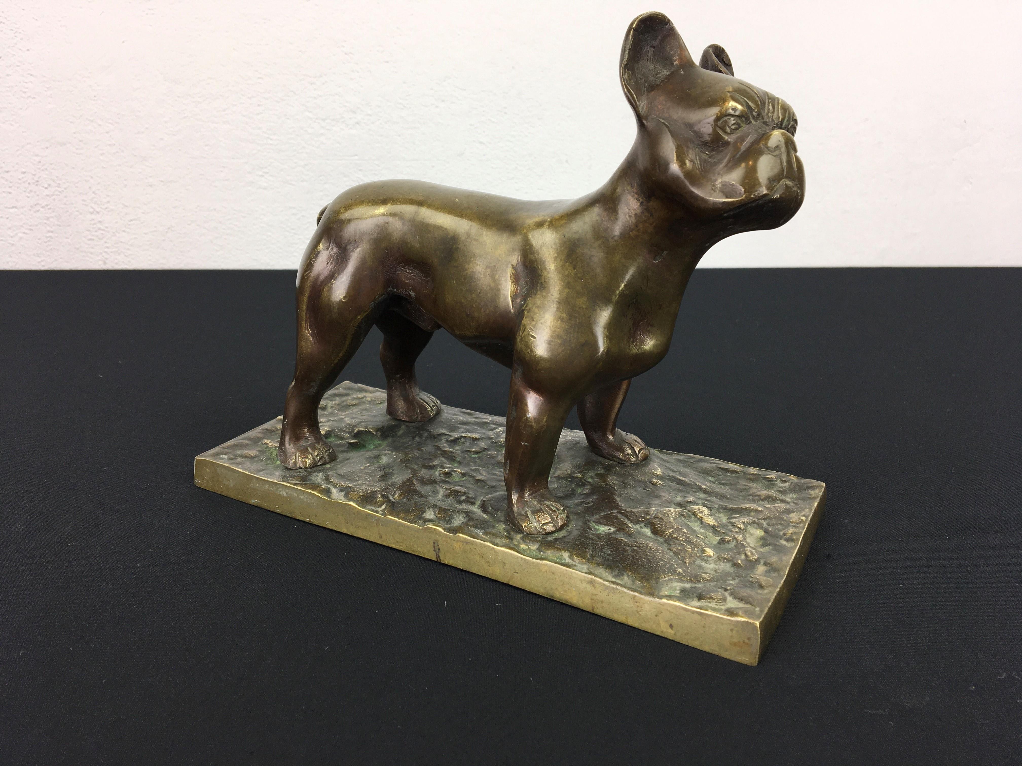 Bronze French Bulldog sculpture. 
This heavy dog sculpture made of cast bronze is not small, see the picture on my hand ! 
It's a standing male Frenchie mounted on a base which is also made of cast bronze.

French Bulldog - Frenchie - Bulldog