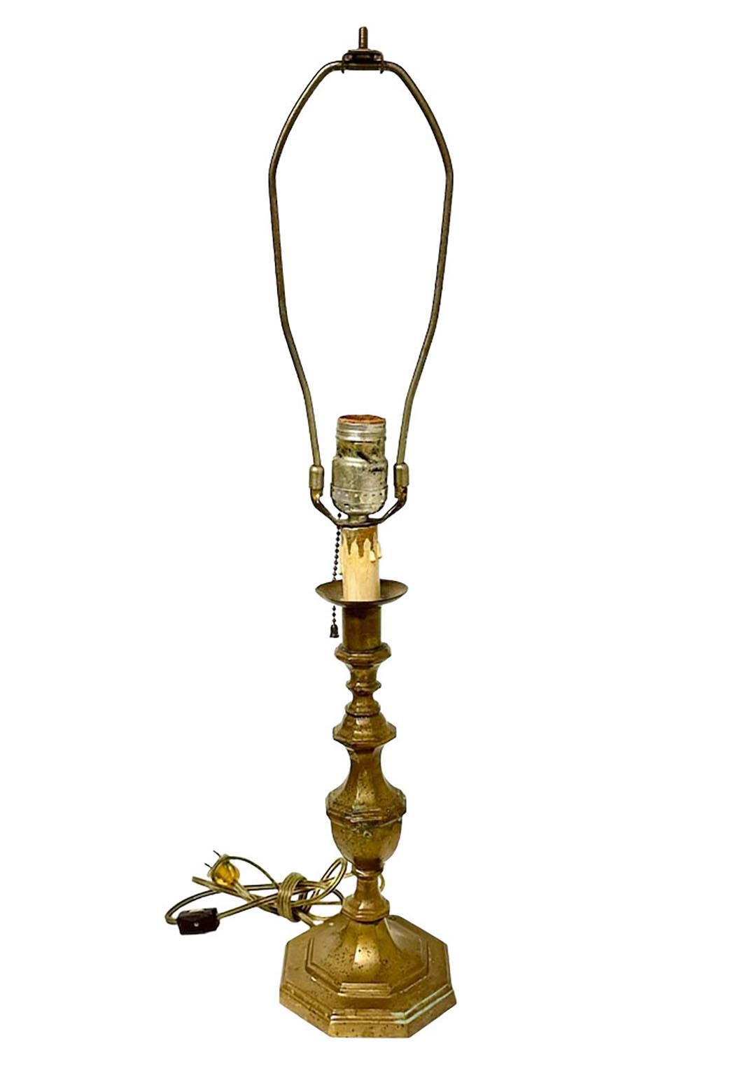 An elegant 19th century French bronze candlestick lamp with pull chain. The cord has a click switch.