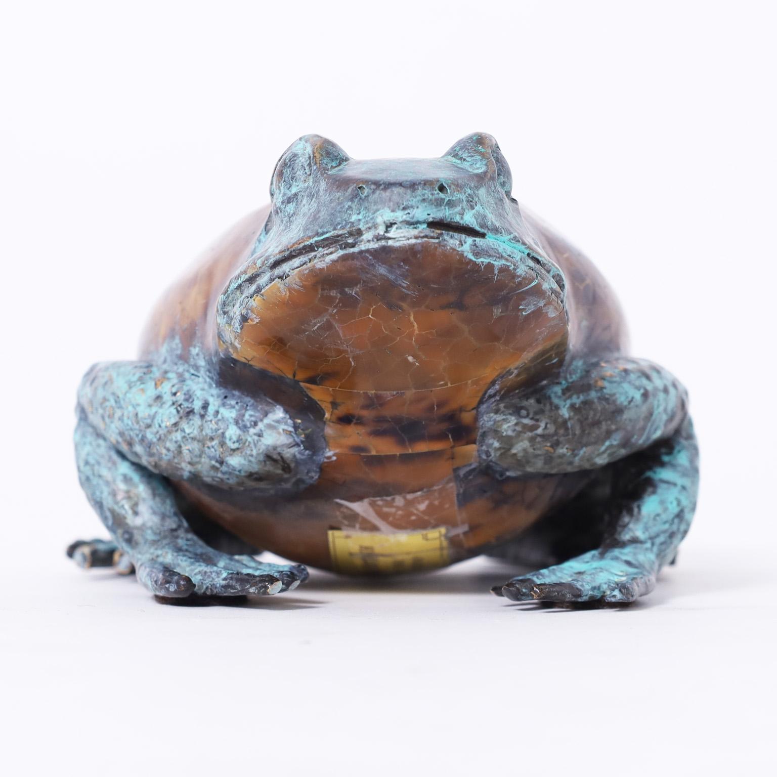 Mid century life size frog crafted in cast bronze with a lush verdigris finish and featuring a tortoise shell body. Signed Maitland-Smith on the bottom.