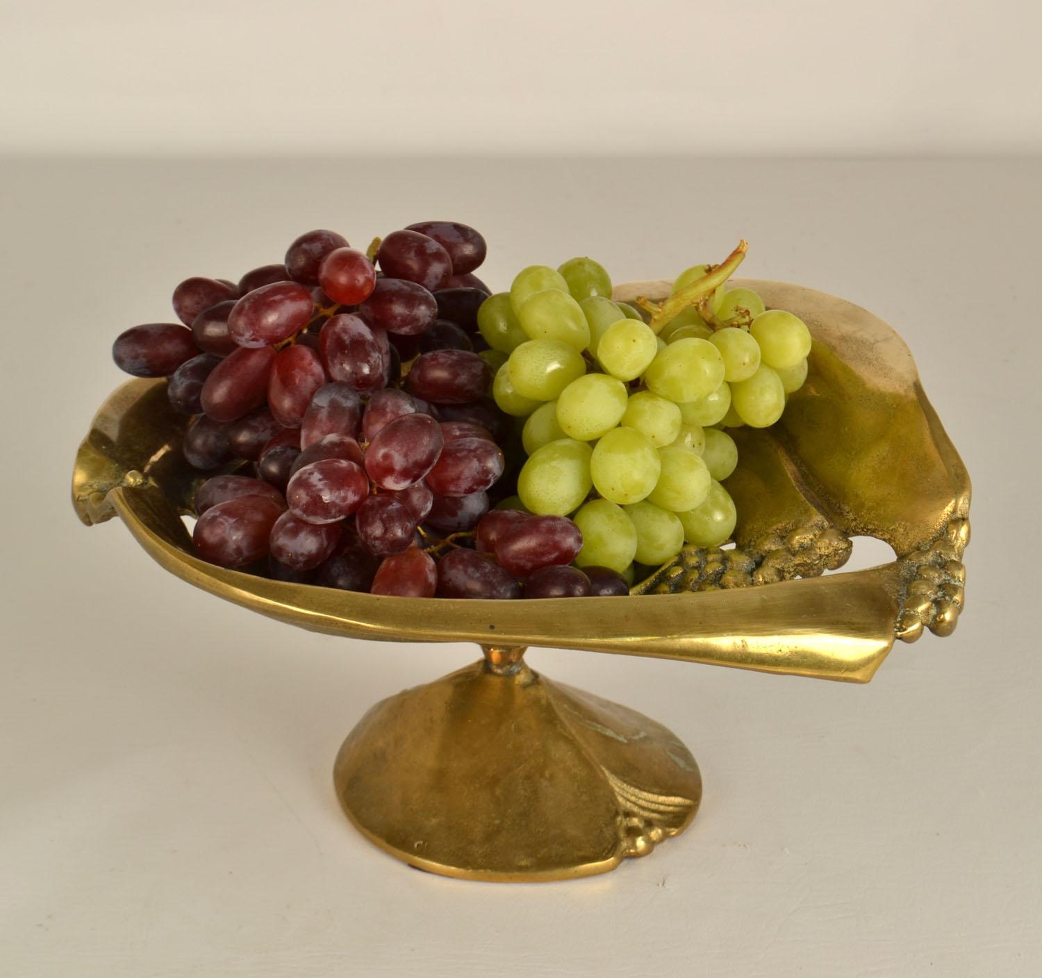 Freeform bronze cast footed fruit bowl decorated with grapes has an open structure and stands on a conical foot.
There is a matching large bowl available. 
See listing LU1001545388112