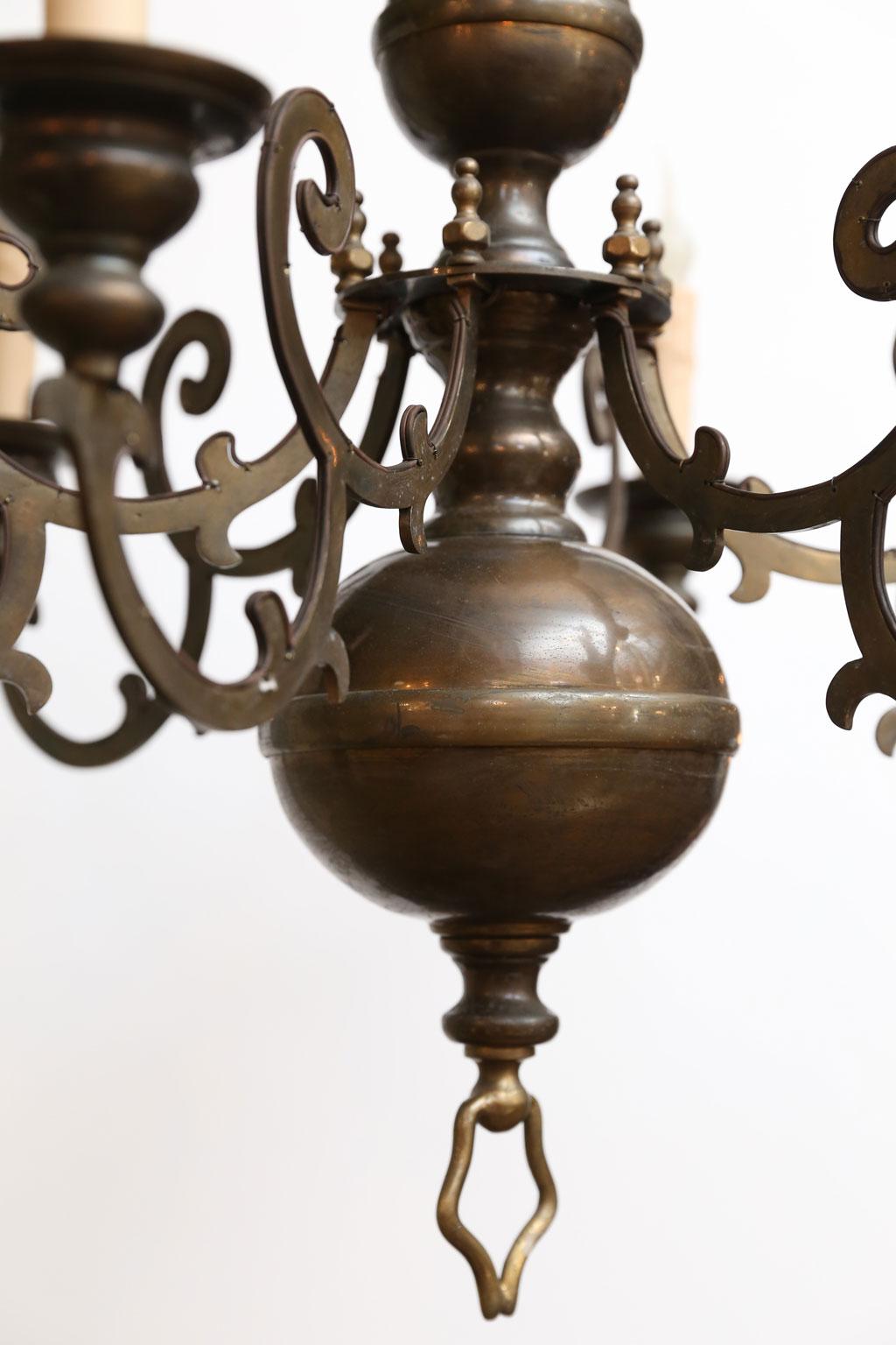 Bronze Georgian-style chandelier (circa 1900) from Belgium. Wonderful patina and color. Unusual six flat Silhouette-like Baroque-style shaped arms. Newly wired for use within the USA. Candelabra-size sockets. Includes chain and a canopy.  It is