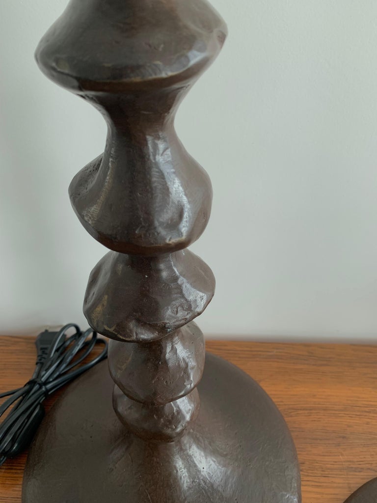 Bronze Giacometti style sculptural table lamps France 1990 a pair.
Each lamp is slightly different sculpted by hand and cast in bronze with the lost wax technique.
The brown patina has been remade recently and the lamps newly rewired to European