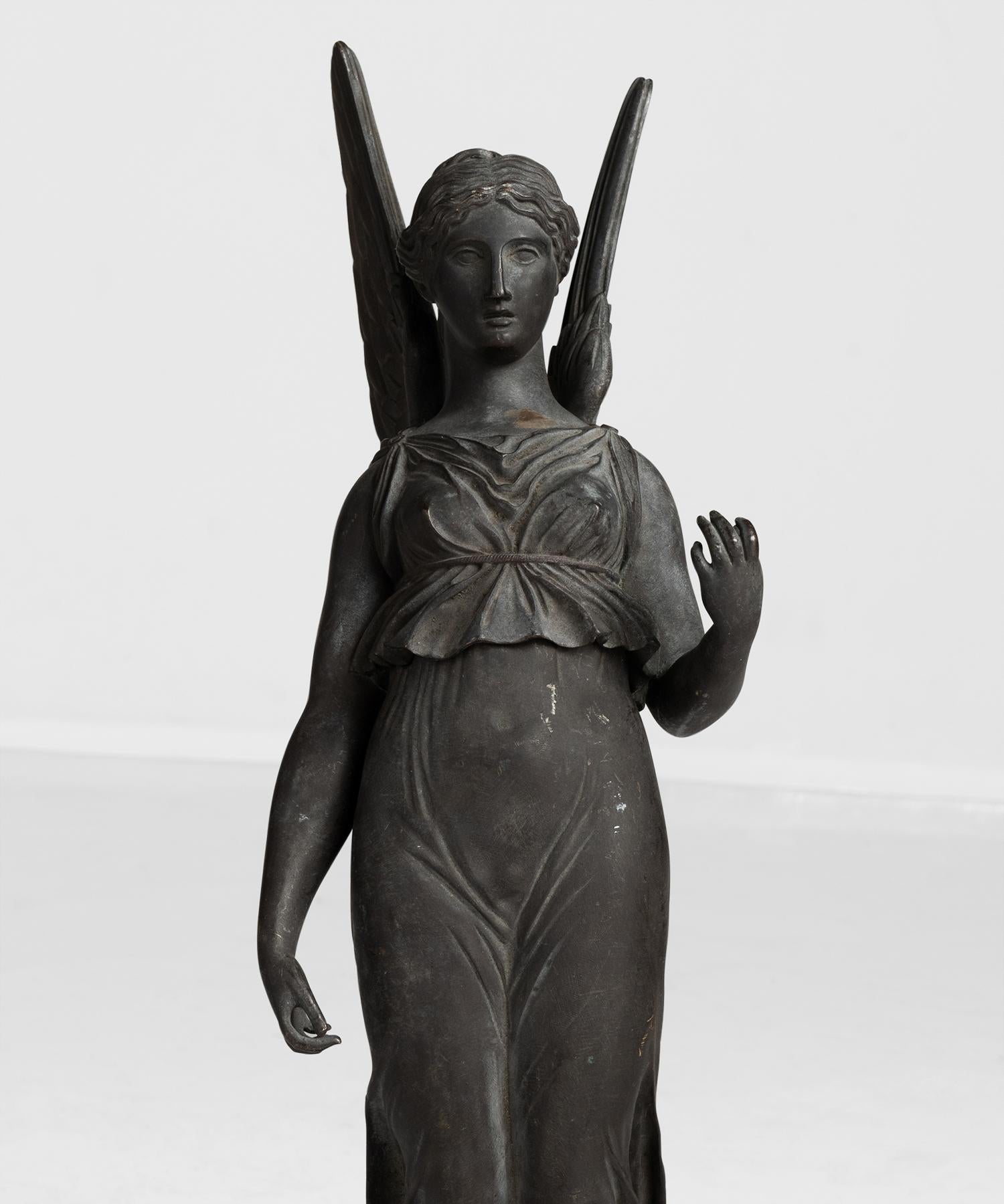 Sculpture fragment featuring the goddess Iris with spread out wings.
 