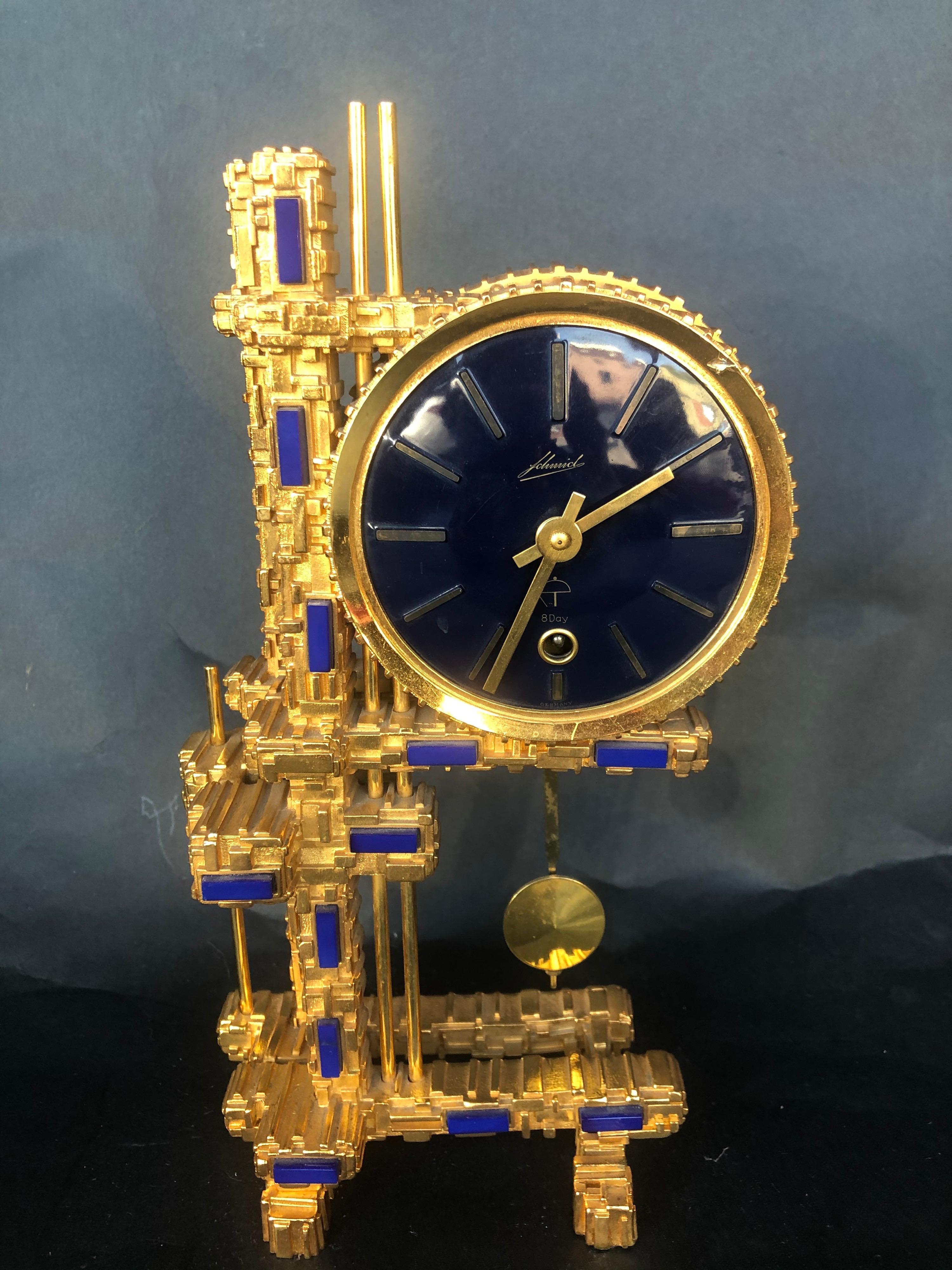 Reloj de bronce chapado en oro con piedras azules firmado J.