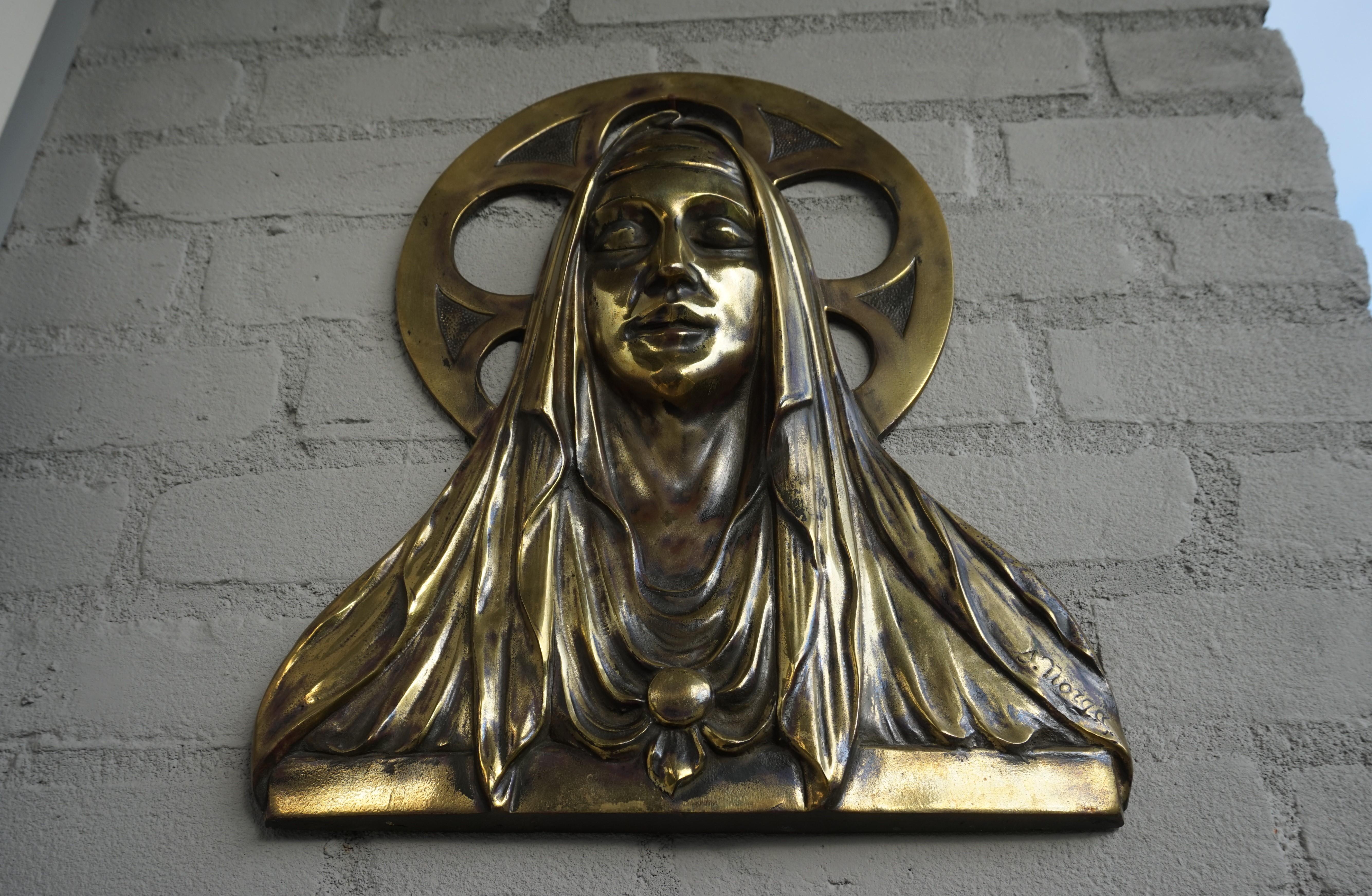 Unique antique bronze wall plaque by Belgian sculptor Sylvain Norga.

This Gothic Revival work of religious art dates from the Art Deco era and it is a little bit of a rare specimen. For some reason, Sylvain Norga almost always created bronze wall