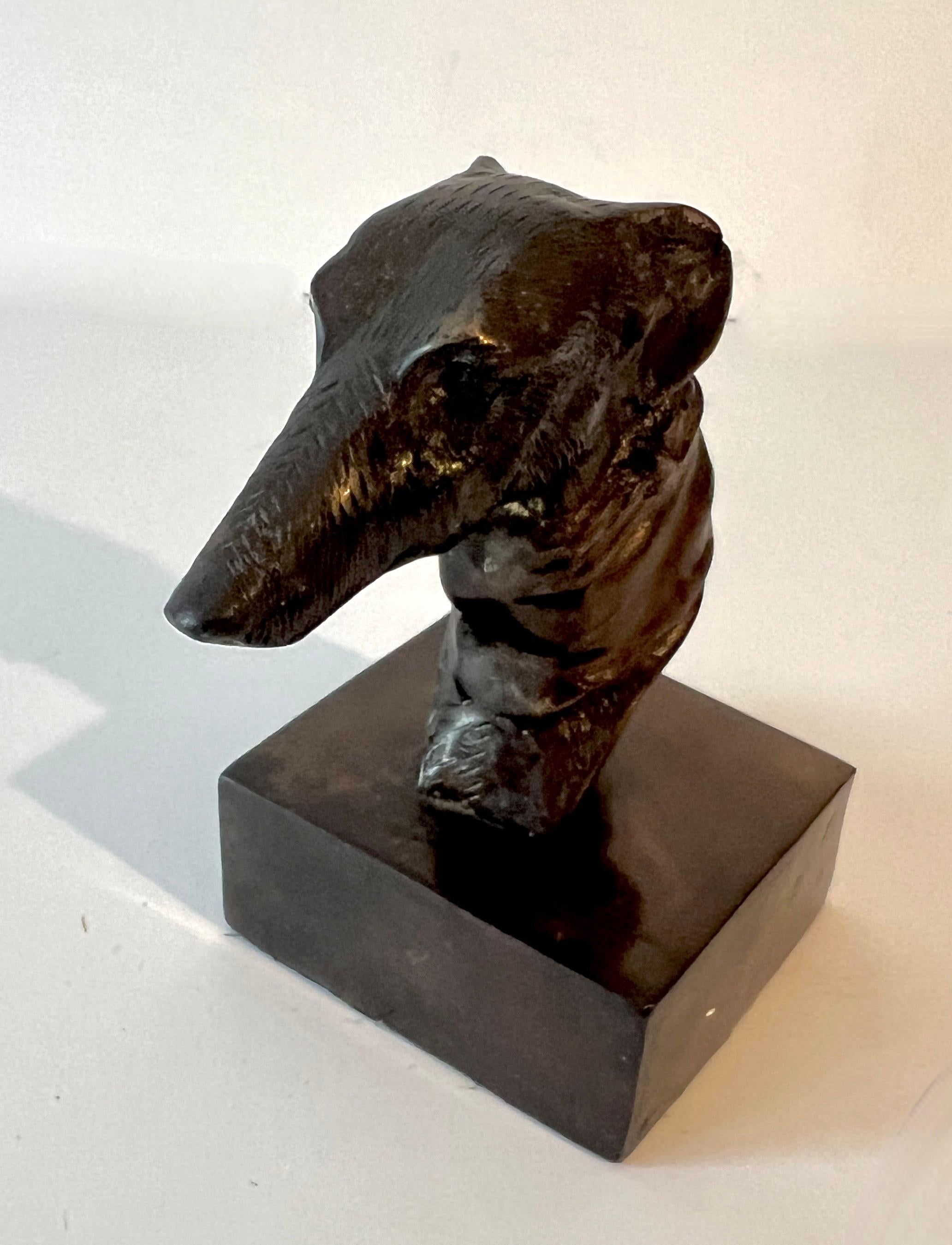 Bookend or Paper weight of a Greyhound head mounted on a Patinated brass base.

A compliment for any shelf or side table, and especially practical on a desk or work station.  The detailing, while simple, is very nice.

We have found the price