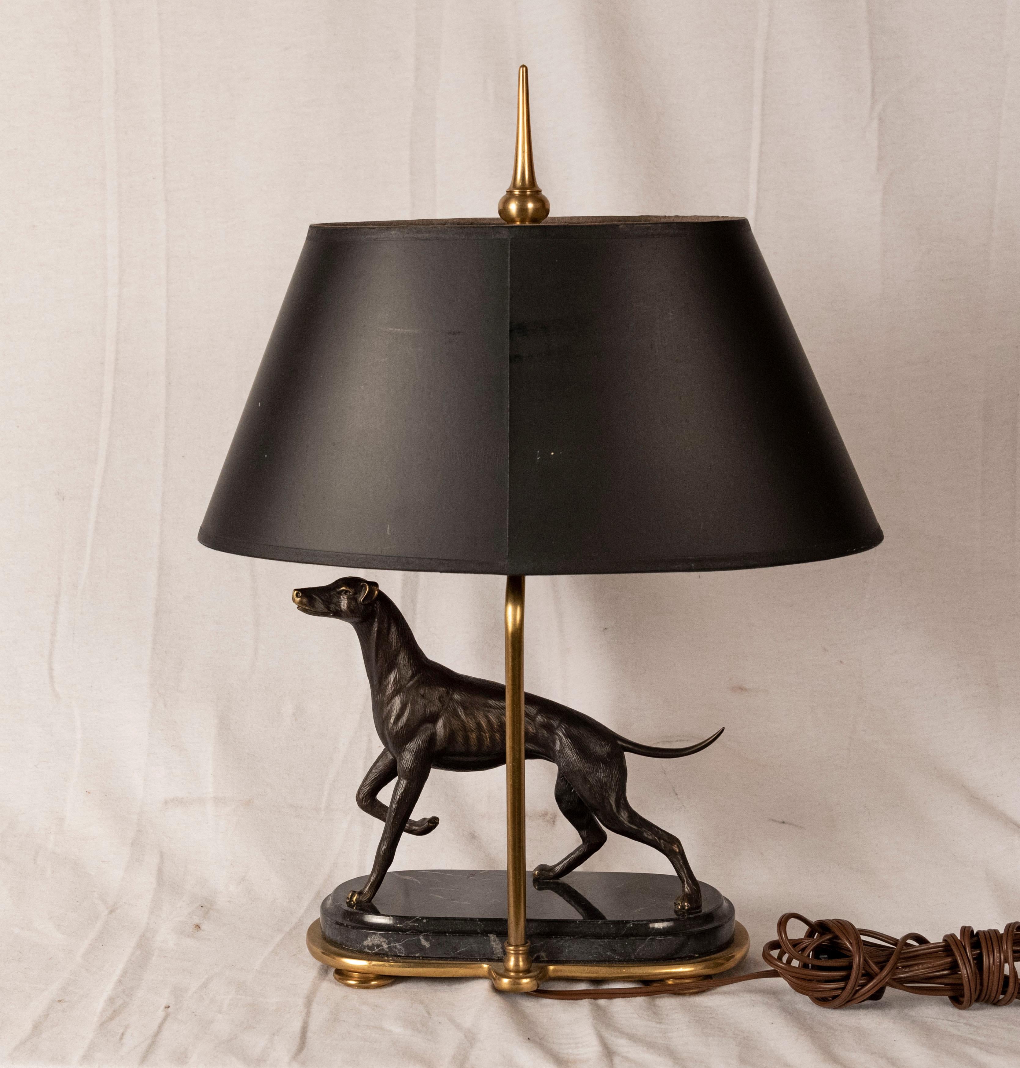 Bronze Greyhound sculpture lamp. Bronze sculpture of a greyhound with one paw raised, on a marble and bronze base, fitted as a lamp, American, 20th century.

Measures: 20 x 14 x 4 in.