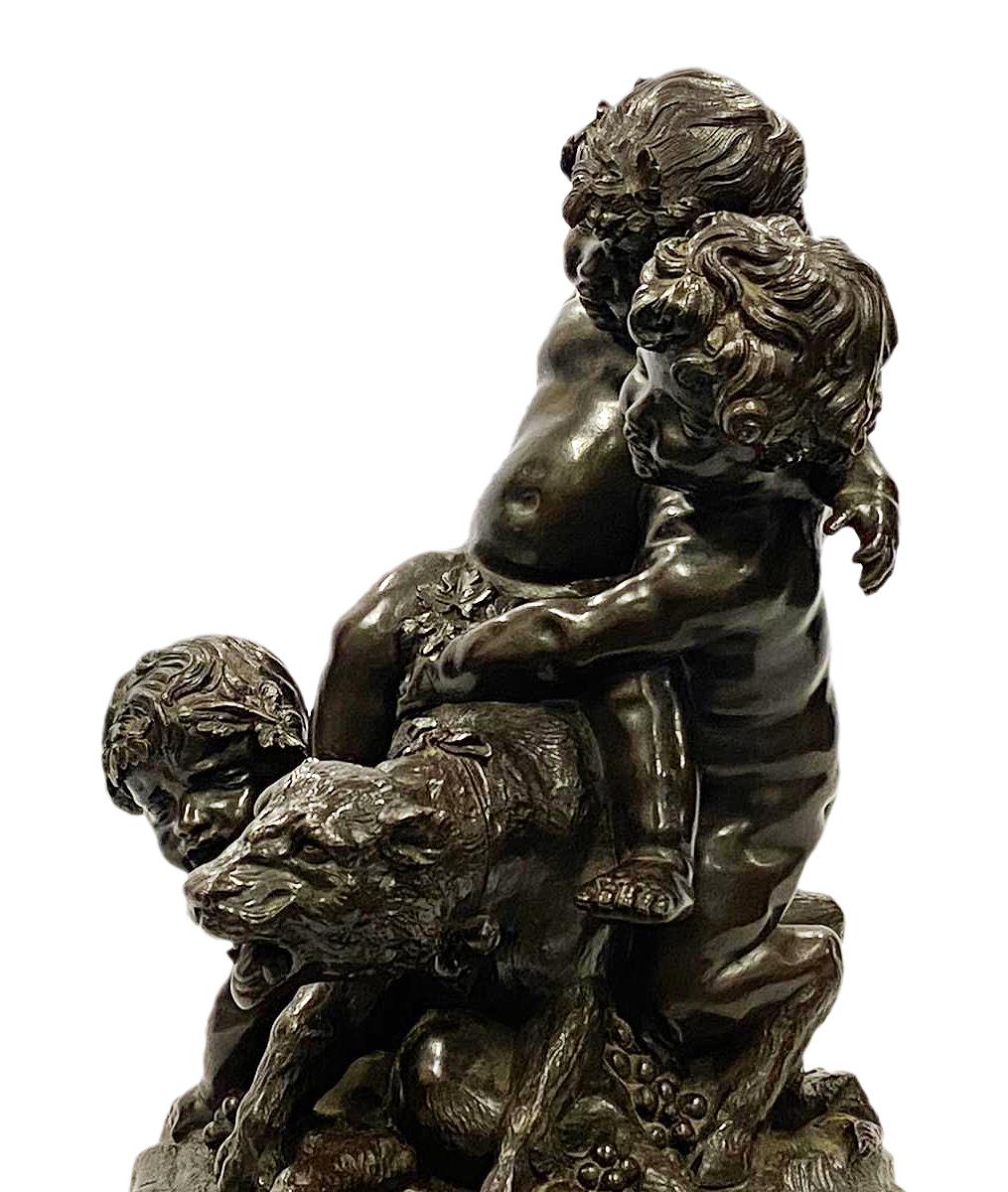 A fine quality 19th century bronze group, depicting three children playing with a Lioness. Measures: 14