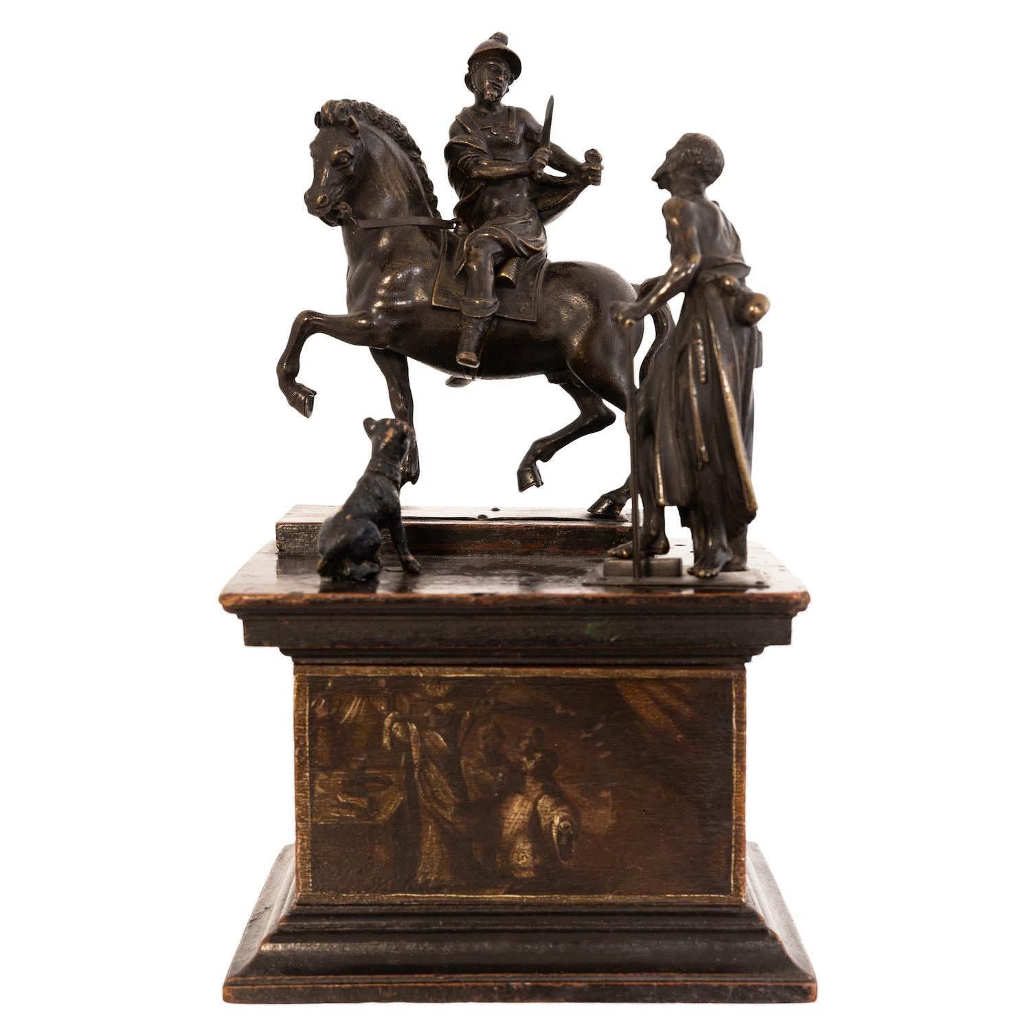 Group of bronze figures on a rectangular profiled wooden pedestal with scenic painting on all sides. Representation of St. Martin on horseback, who is about to share his coat with the beggar. The beggar is accompanied by a dog. Finely worked with