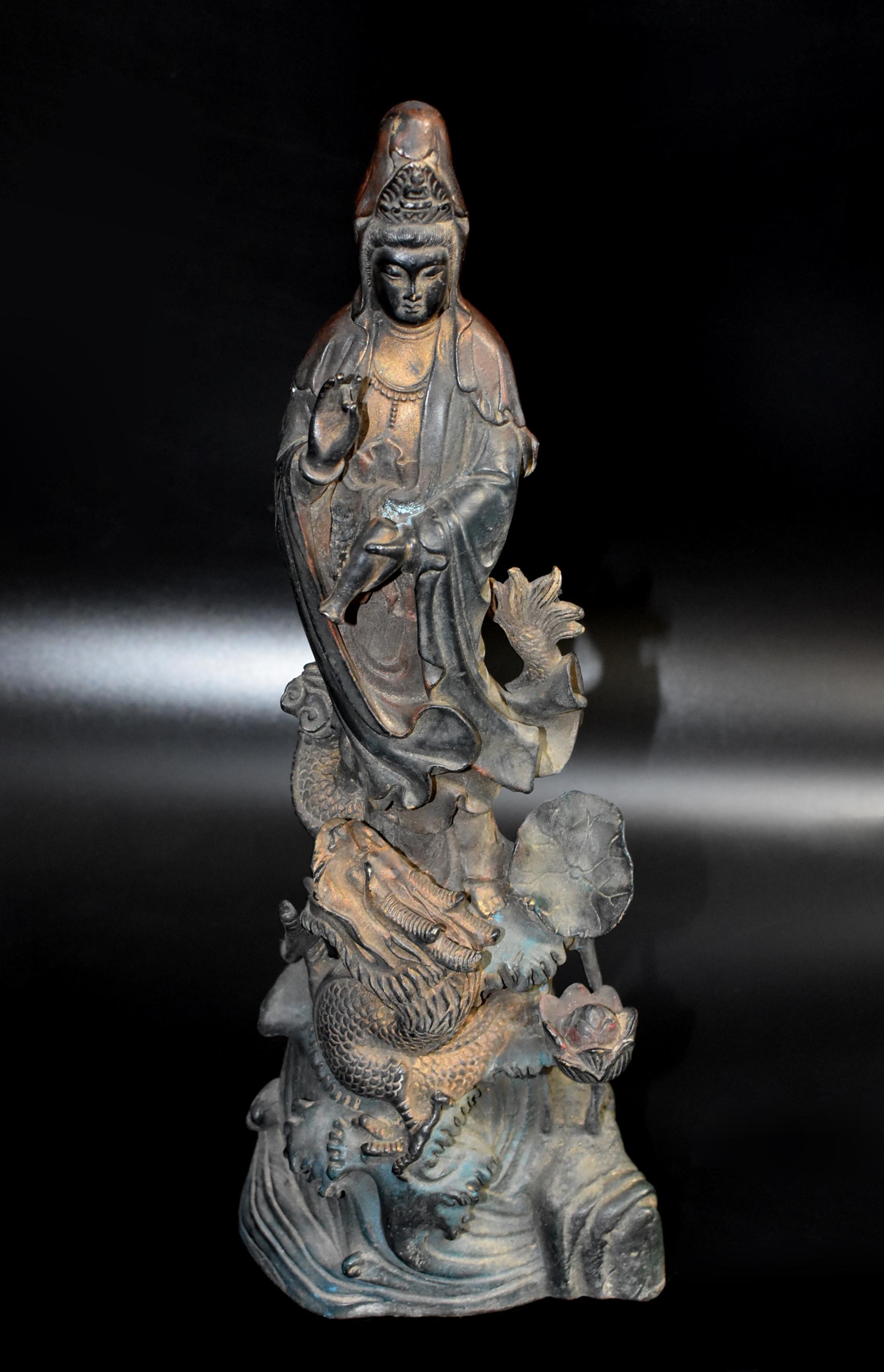A beautiful standing polychrome Guan Yin statue on dragon. The graceful figure wears an elegantly draped robe and beaded necklace. The sensuous full faces with eyes casting a serene and meditative aura, below evenly arched eyebrows, the forehead