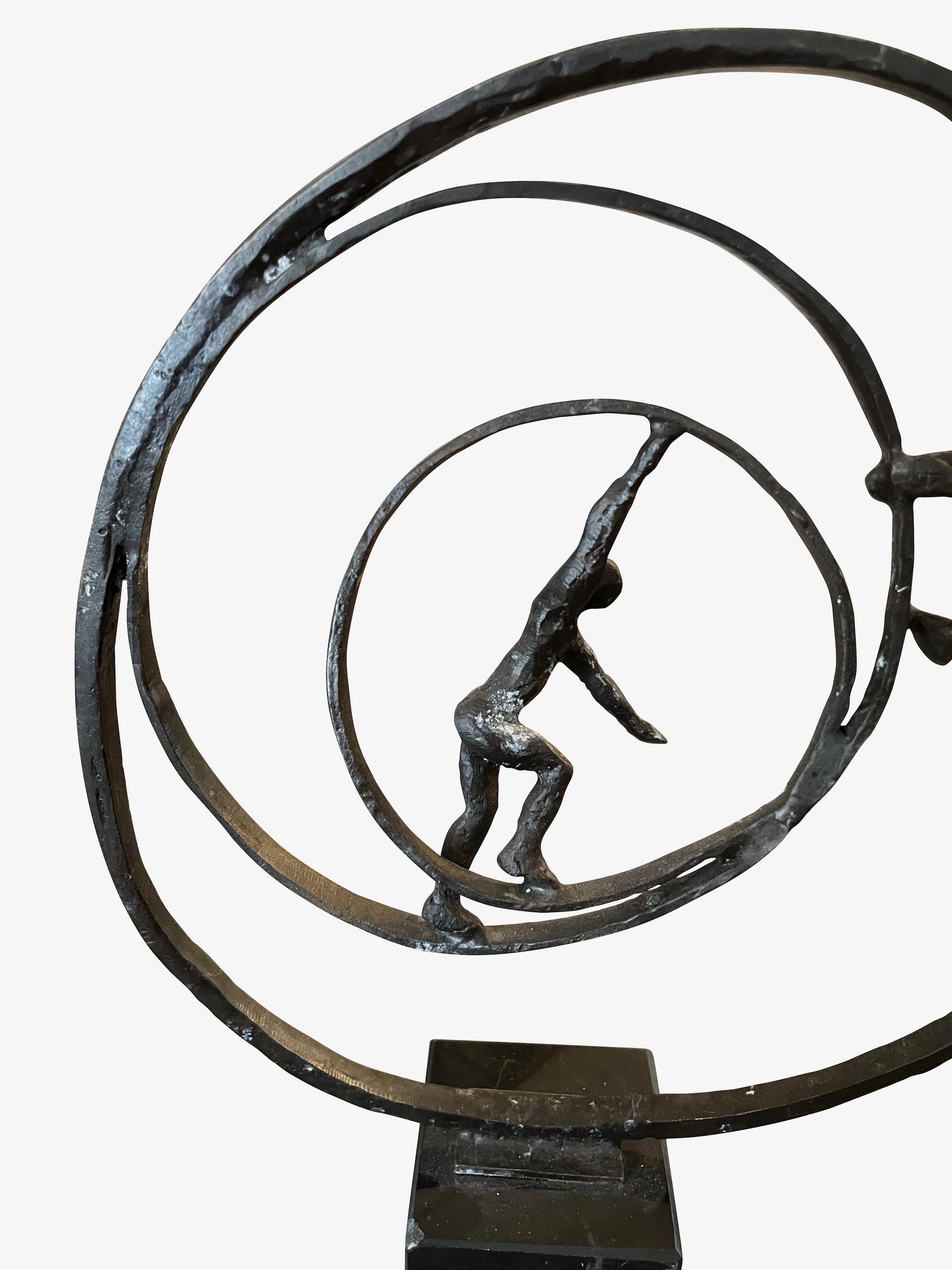 Contemporary Belgian hammered iron rings with two male figures.
Push and pull in motion.
Three concentric circles.
Mounted in marble cube measures 2.5