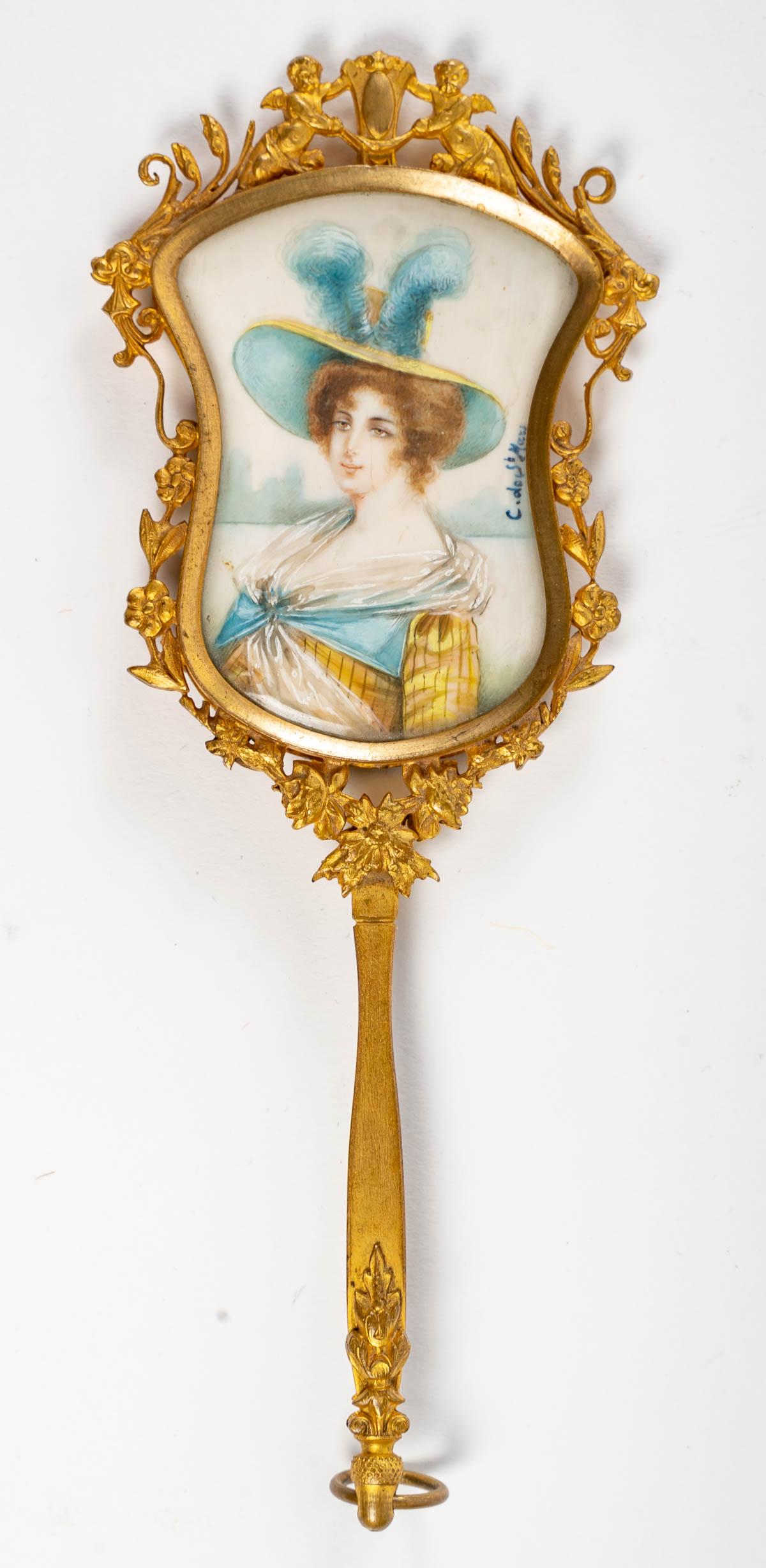 A beautiful gilt bronze hand mirror with a miniature painted and signed on the back, 19th century, Napoleon III period.
Measures: H: 17 cm, W: 7 cm, D: 1 cm.

 