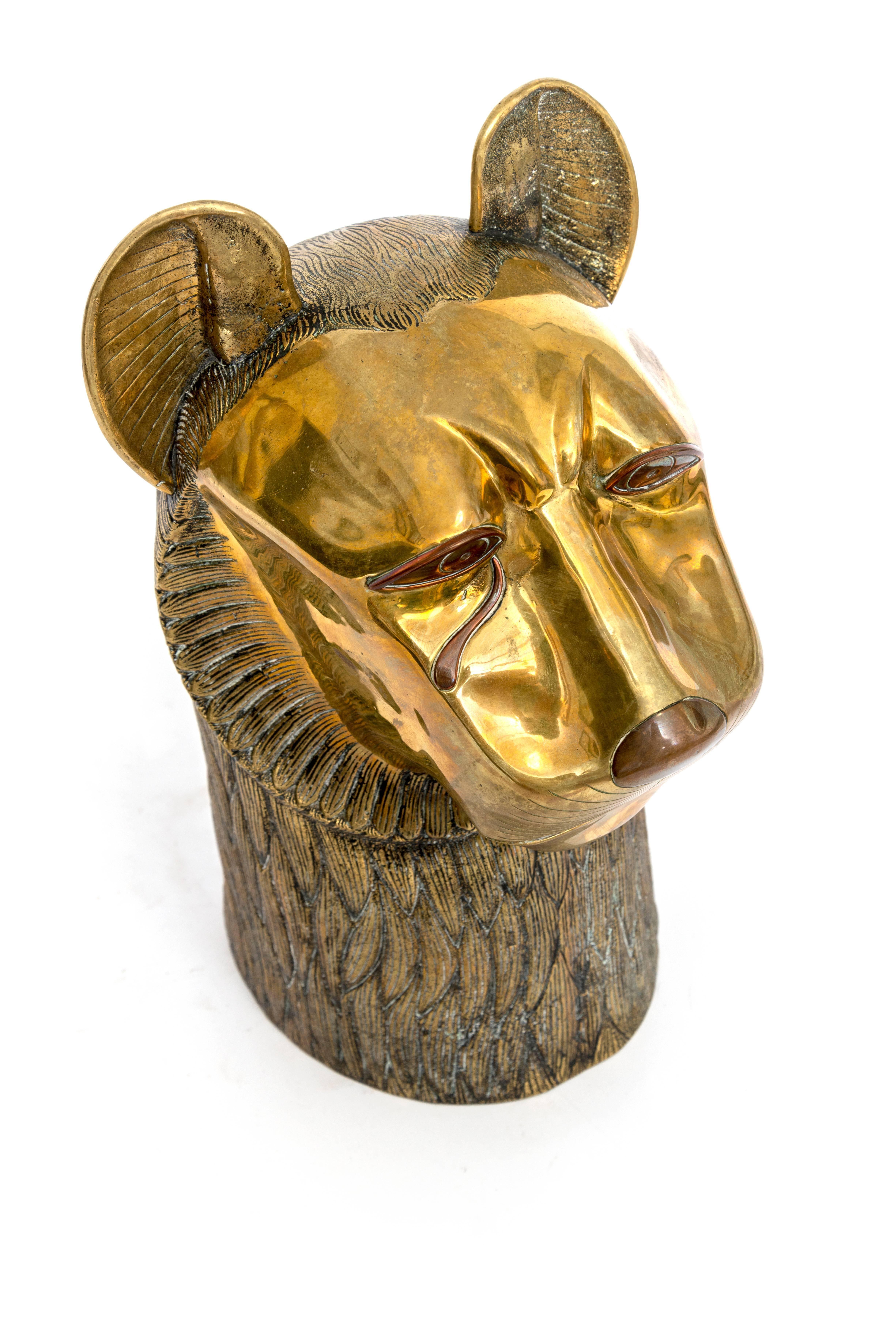  Small standing tabletop sculpture in bronze with a detail of the face of a lion, with a teardrop falling from one of his eyes.