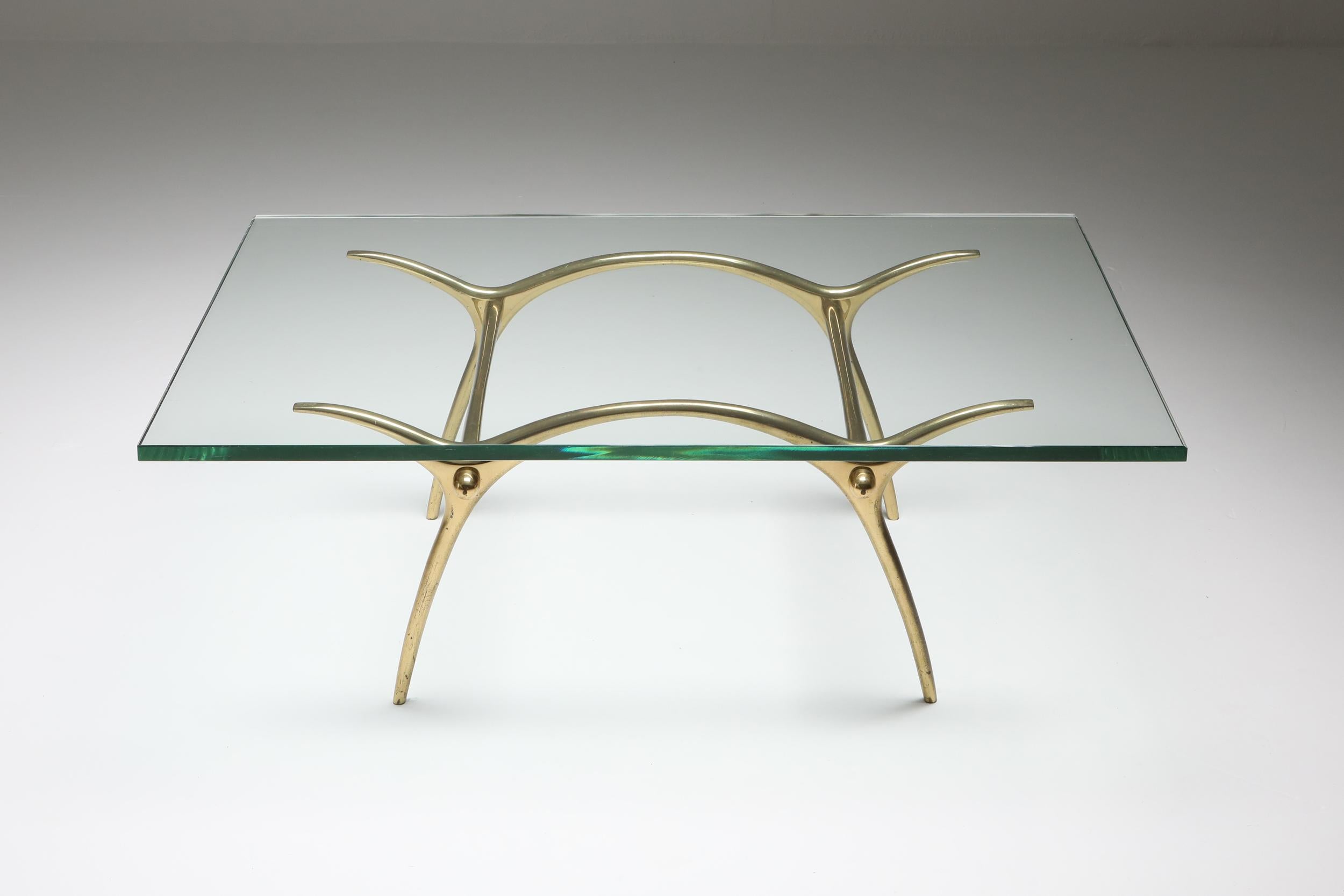 Kouloufi cocktail table, polished bronze, Belgium 1970s

the base is composed of double arches which are connected to each other via two stretchers.
The base supports a thick clear glass top.
By Kouloufi, Belgium, circa 1970.
Measures: L 115