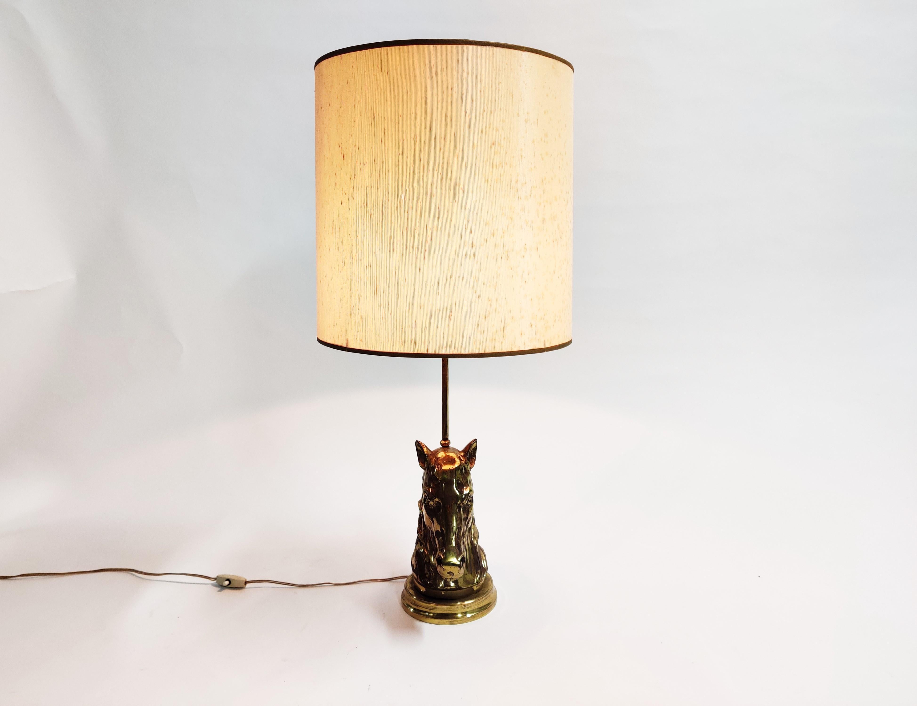 Bronze horse head table lamp in the style of Maison Jansen.

The brass horse head has beautiful details and slight patina. 

Comes with a period lamp shade.

Stylish table lamp with a luxurious appeal.

Tested and ready for use. To be used