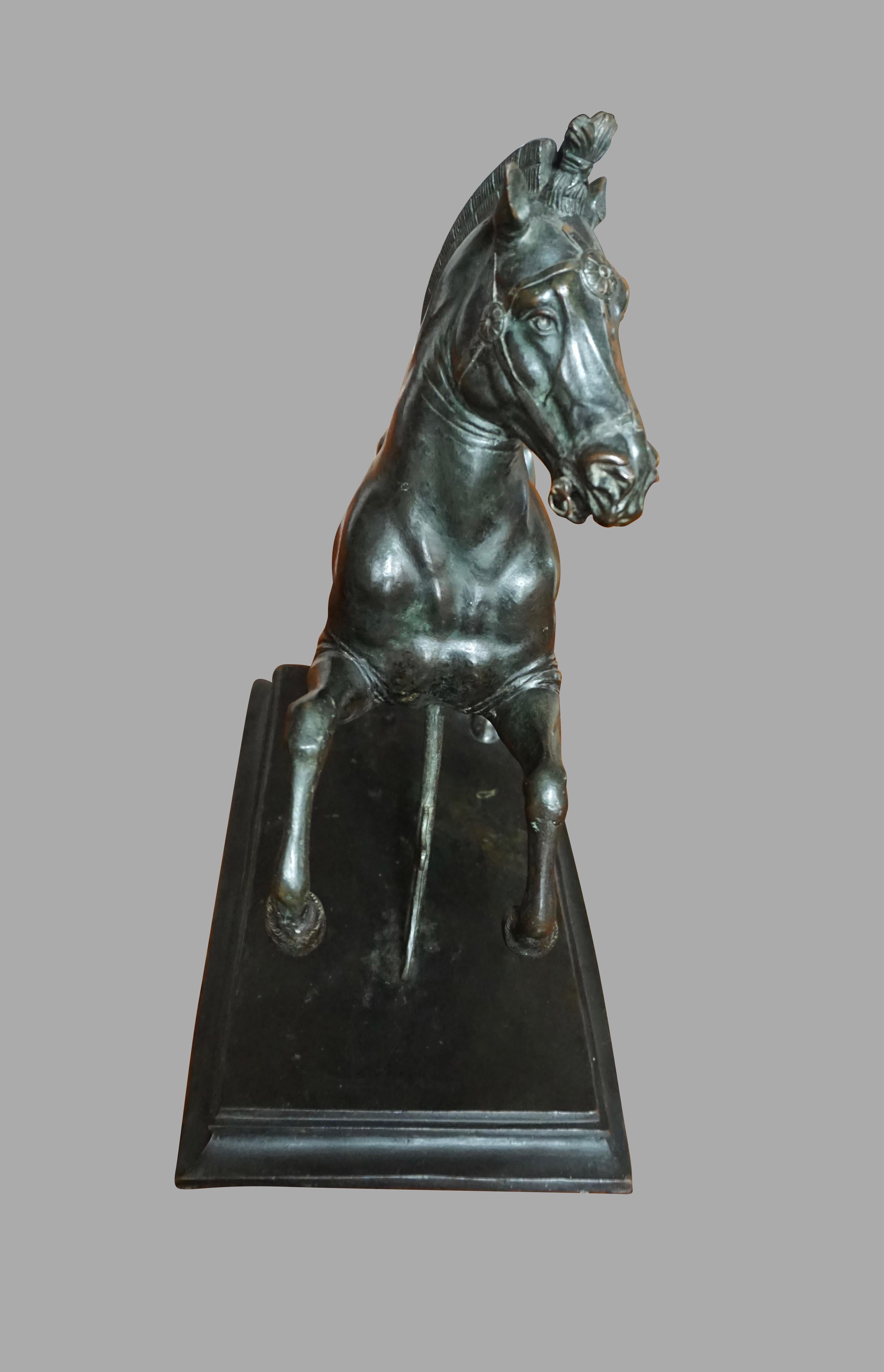 A finely cast continental patinated bronze figure of a galloping horse in the Renaissance manner, now on a contemporary painted faux marble wooden plinth, circa 1850.