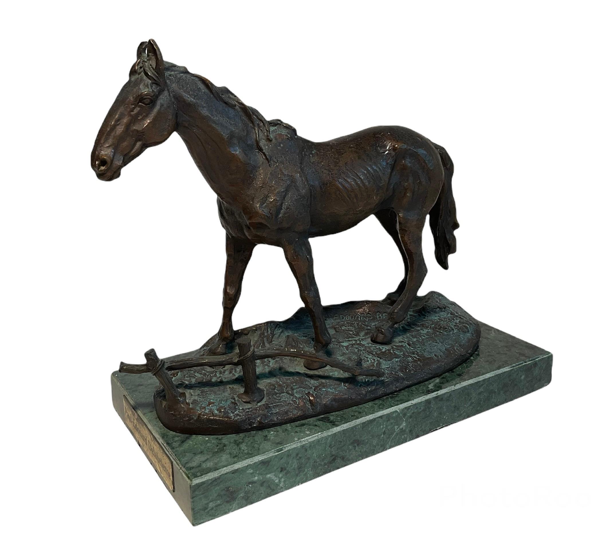 This is a bronze sculpture of a horse after Paul E. Delabrierre. It depicts a horse standing up over soil in front of a broken “wood” fence. The sculpture is supported by a rectangular green marble base.