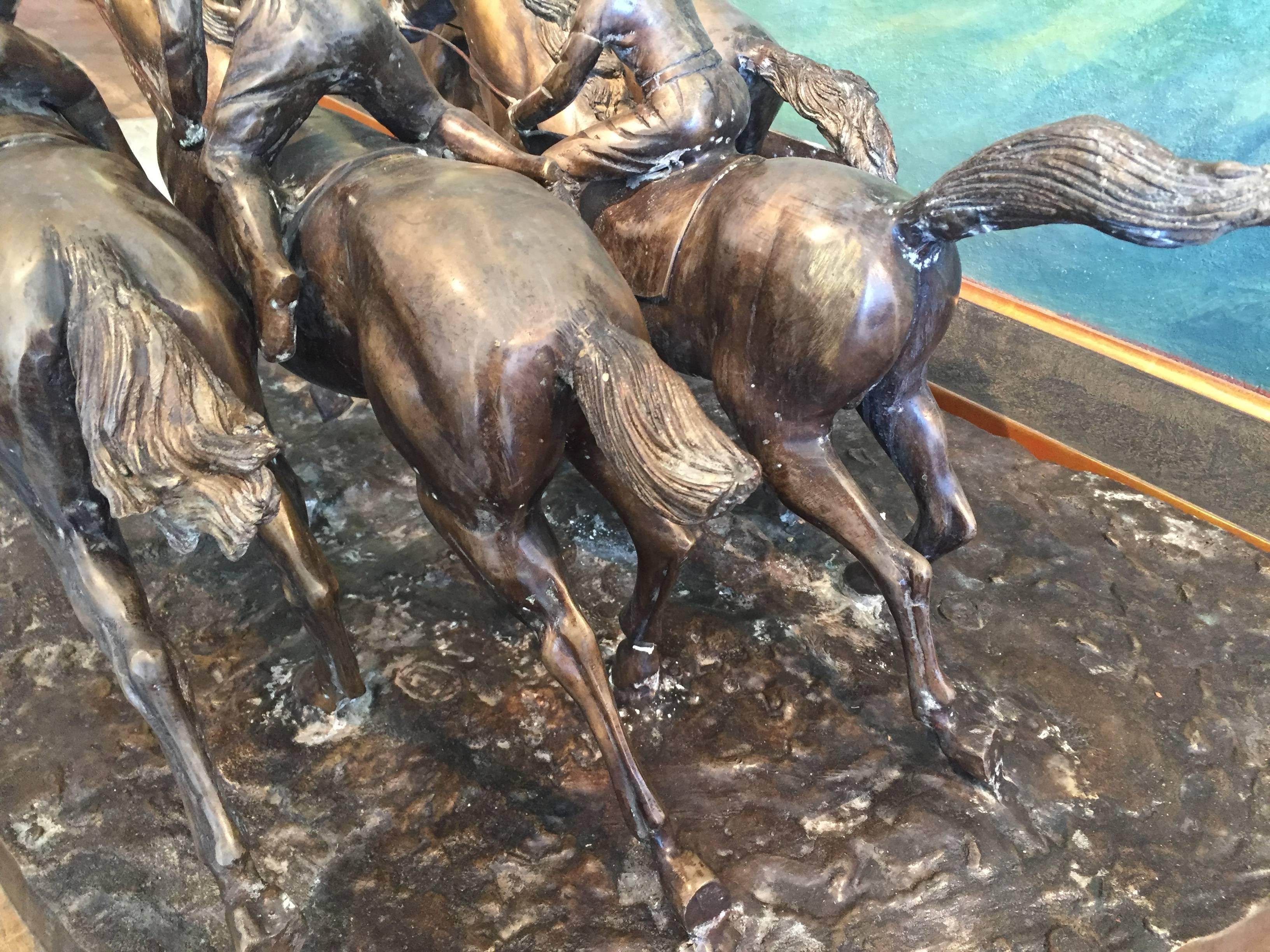 Bronze horse race with four horses, and four riders. Great sculptural delineation of horses and riders.