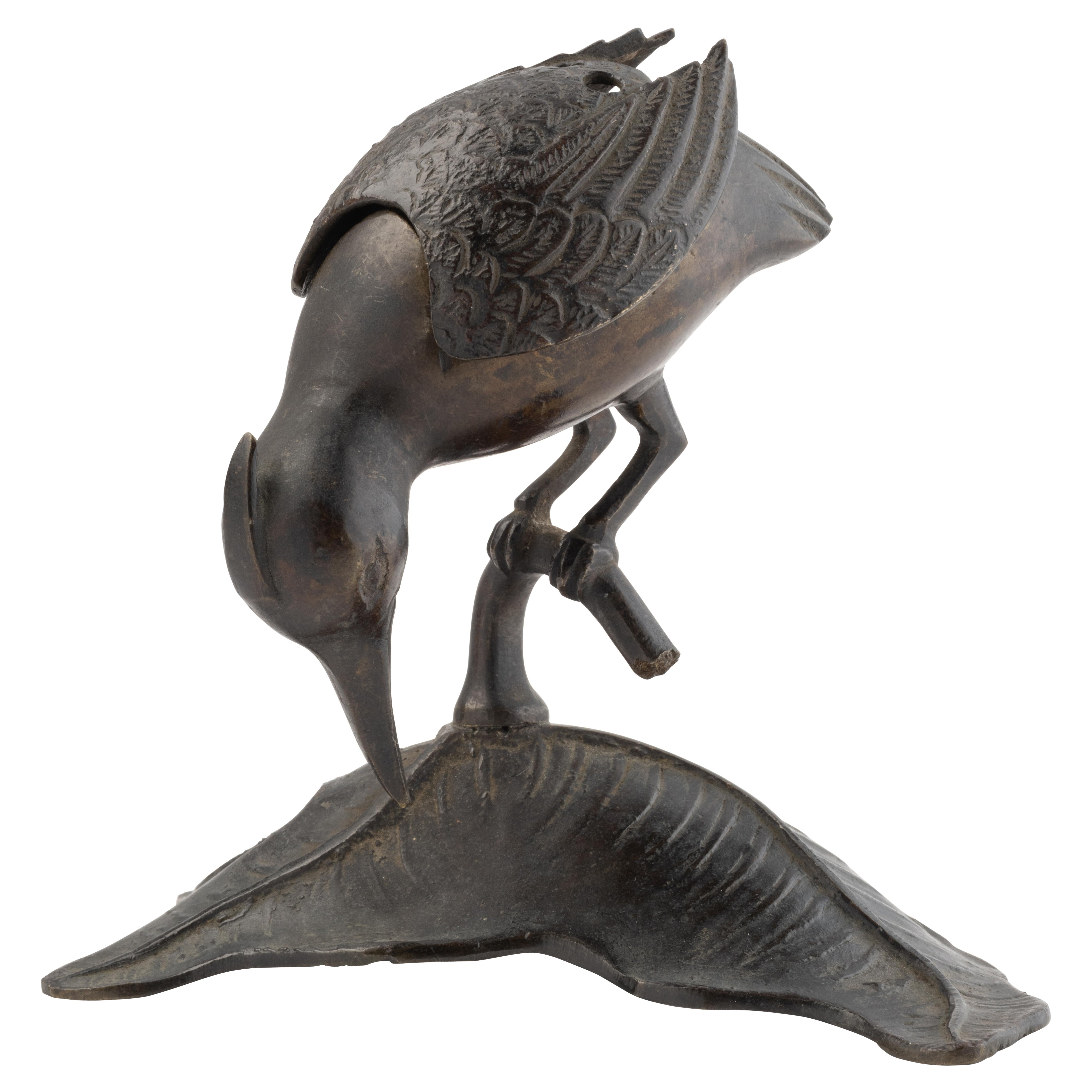 Bronze incens bruner in the form of a Kingfisher standing on a leaf