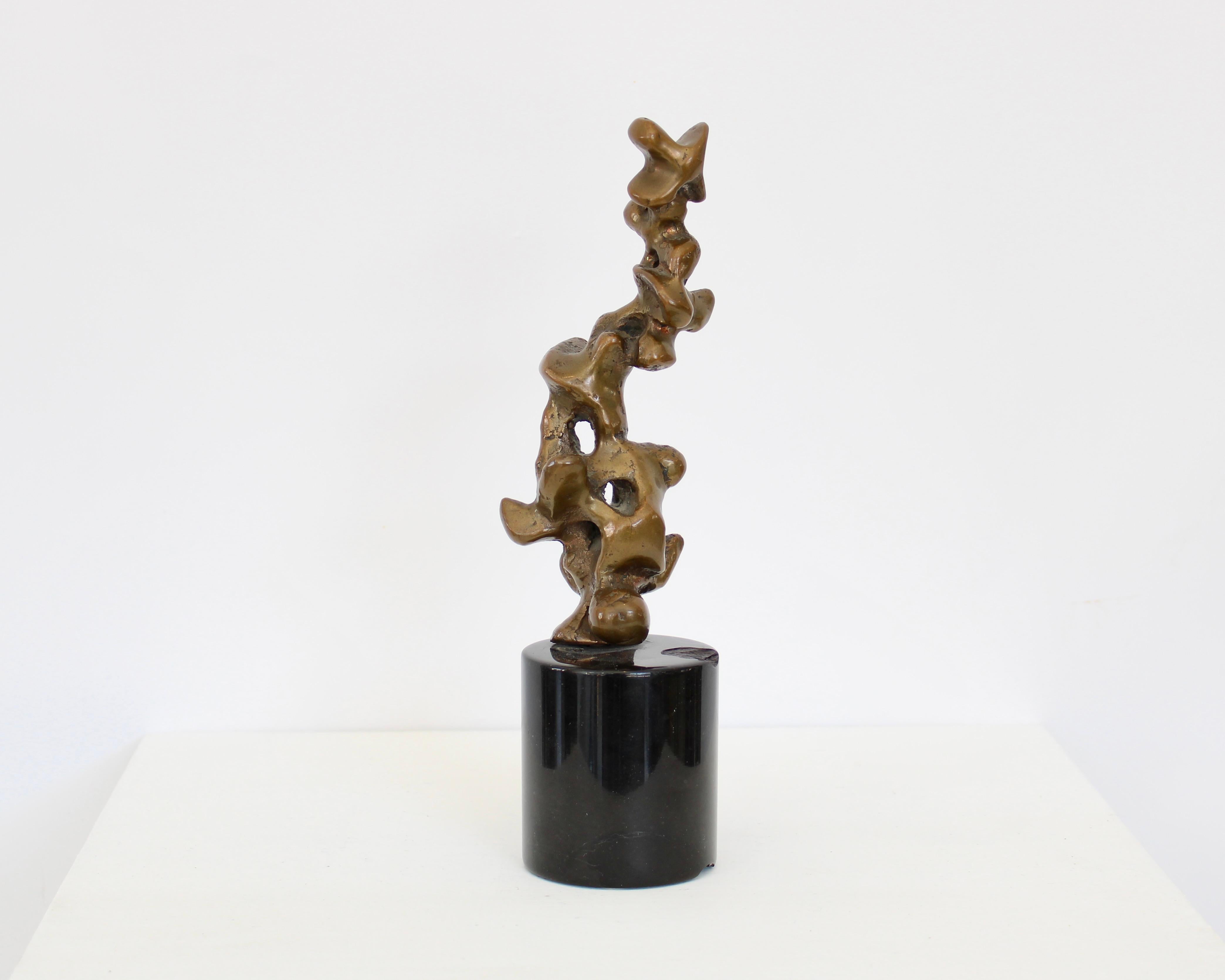 Abstract bronze Italian sculpture by Claudio Trevi (1928 - 1987)
on black marble base. Signed Trevi 7/7 
The black round marble base has chips as shown in last photograph. 
It does not distract from the abstract and graceful movement of the abstract