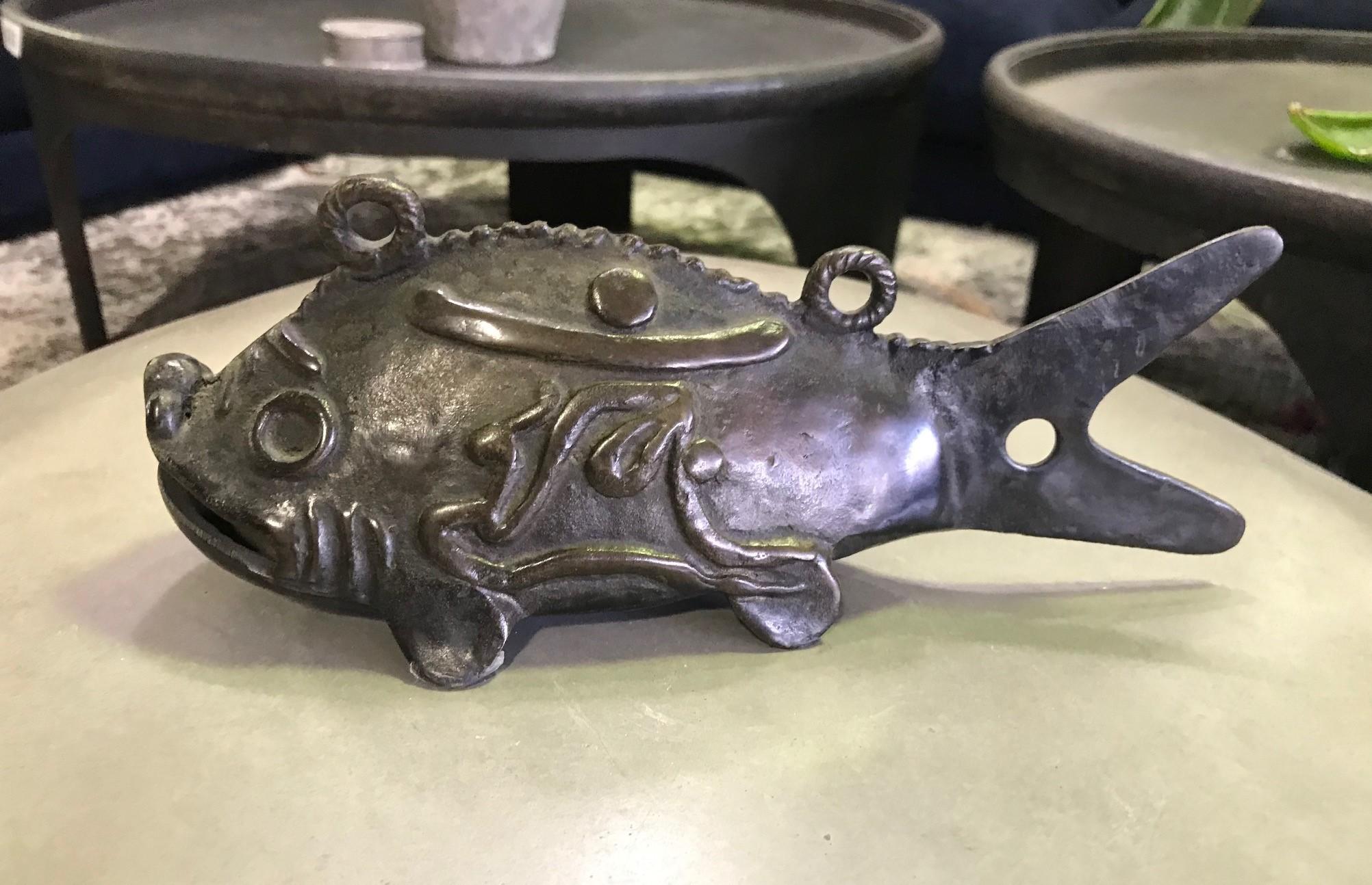 A fantastic, heavy bronze Japanese hanging fish (likely Koi) bell/ chime from the late Edo period. The patina on the piece is superb. It glows in the light. The fish has two top loops for hanging and Japanese kanji characters on each side.

This