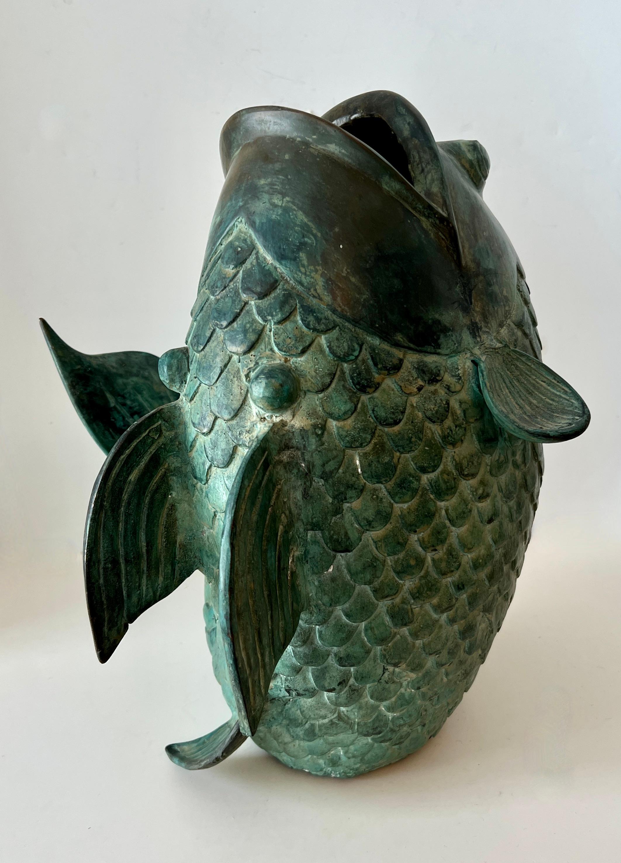 this beautifully designed Koi Fish is the perfect size to be a decorative piece. centerpiece, flower vase, or even (with a little ingenuity) be a fountain.

The bronze is very detailed and also with a perfect amount of patination.   Great for an