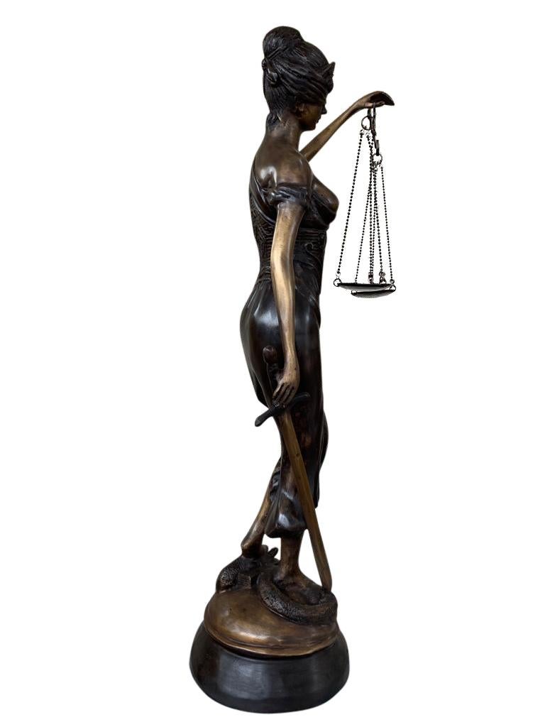Stunning bronze statue of Lady Justice, the Roman Goddess of Justice (equivalent to Greek goddess Themis). Justice is shown with a blindfold, holding the scales and standing on the snake with sword in hand. Hence we have the phrase justice is blind.