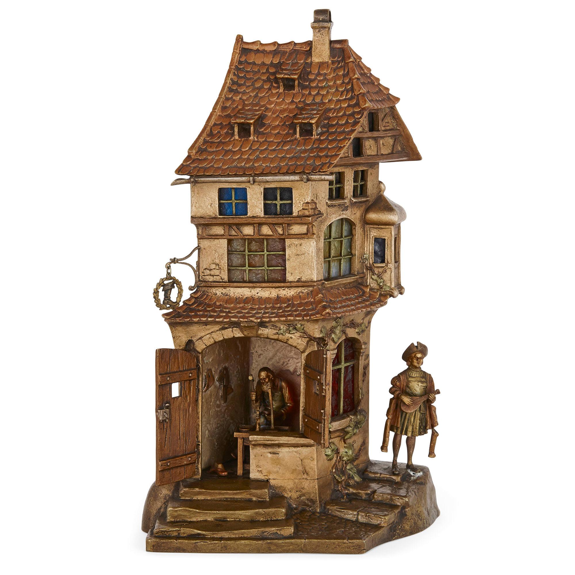 Bronze lamp in the form of a townhouse by Bergman
Austrian, circa 1900
Measures: Height 30m, width 17cm, depth 10cm

This delightful cold-painted bronze lamp was crafted by the famous Viennese foundry owner, Franz Xavier Bergman. Franz Xavier