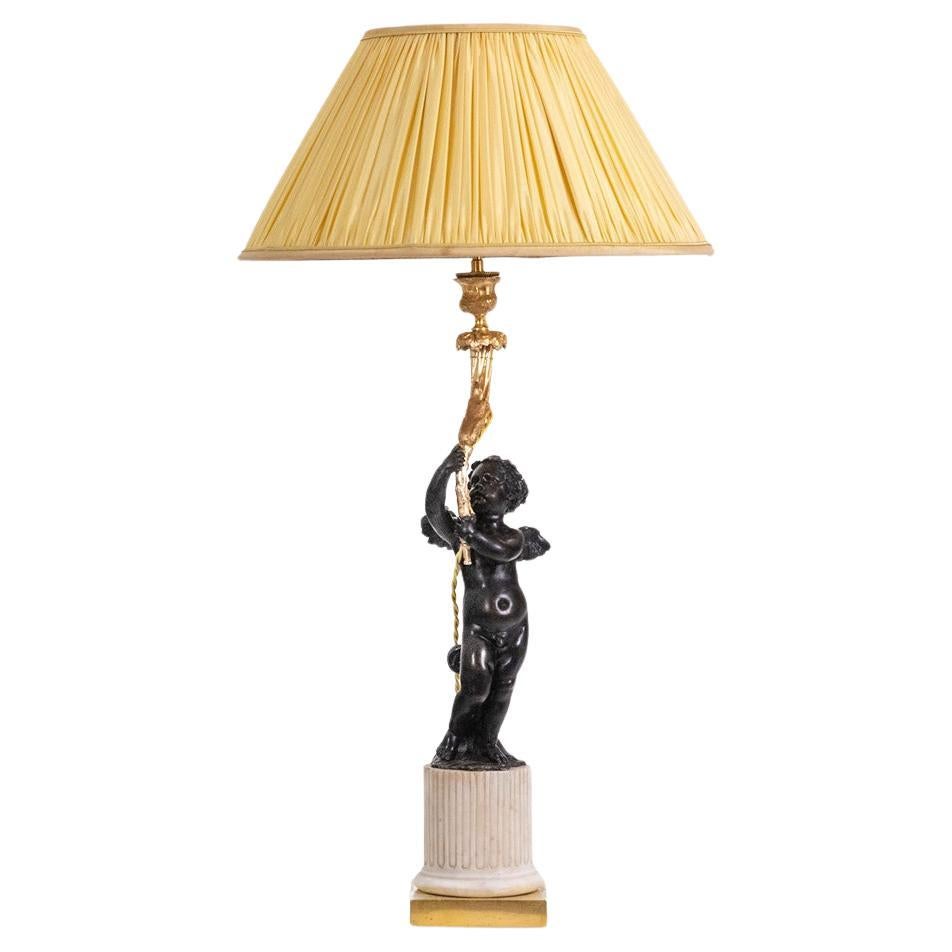 Bronze lamp representing a putti, marble base. Circa 1880. For Sale