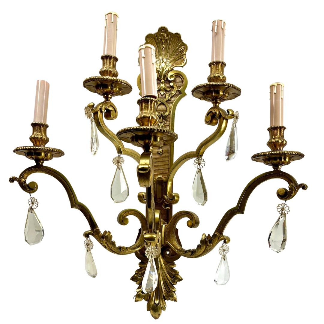 Bronze sconce (electroliers) in the Louis XVI style,  with 5 candle-fittings for electric lamps.
Decorated with ribbons and drapery with tassels and each having 5 arms with rococo scrolls and detail supporting a faux candle in white.

In excellent