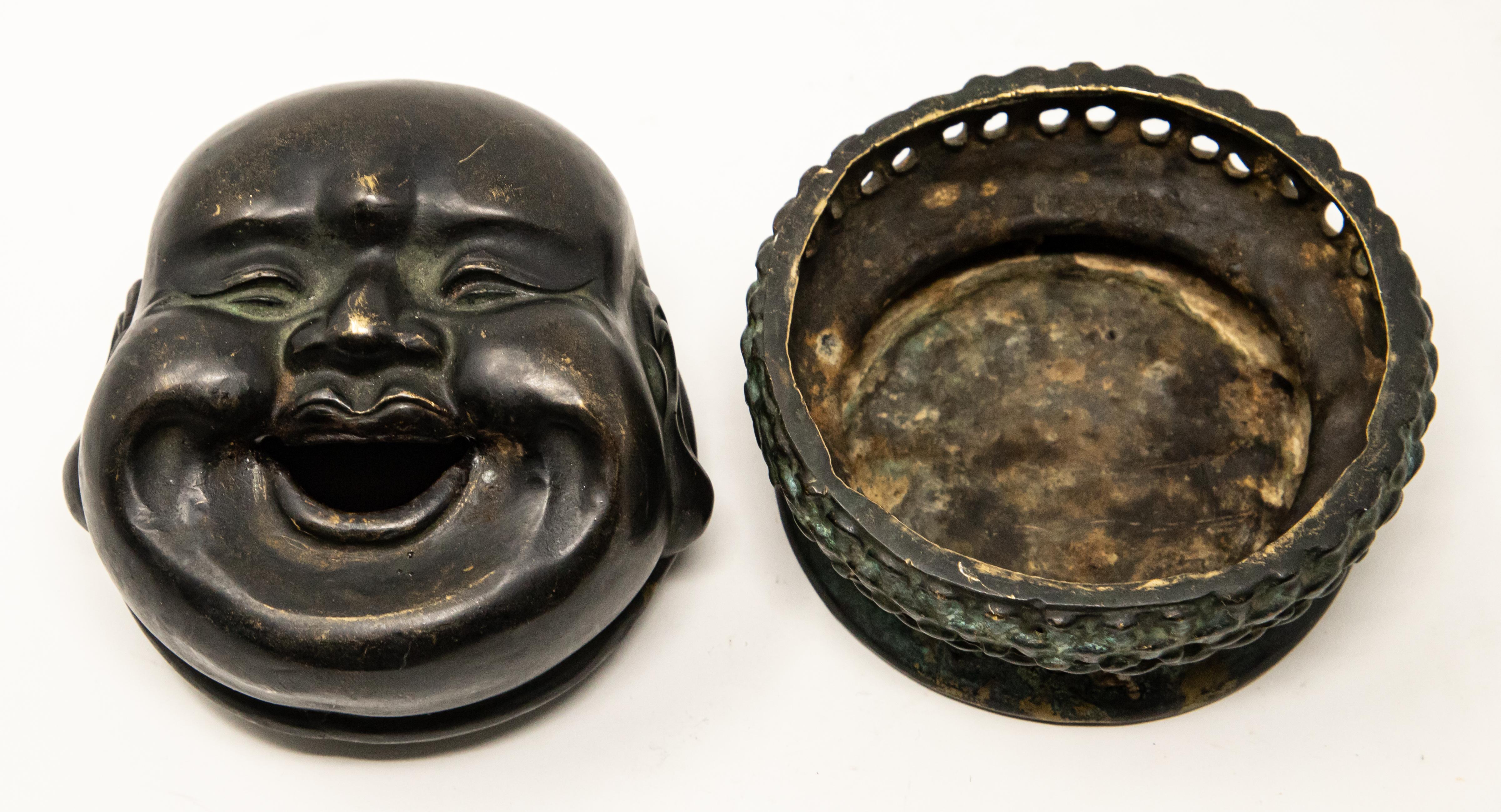 Offering this unforgetful Chinese laughing budai censer. Starting on the bottom of the piece is a lotus flower surrounded by numerous symbols. Once flipped the base of the censer has drilled holes in the sides and is shaped like a lotus blooming.