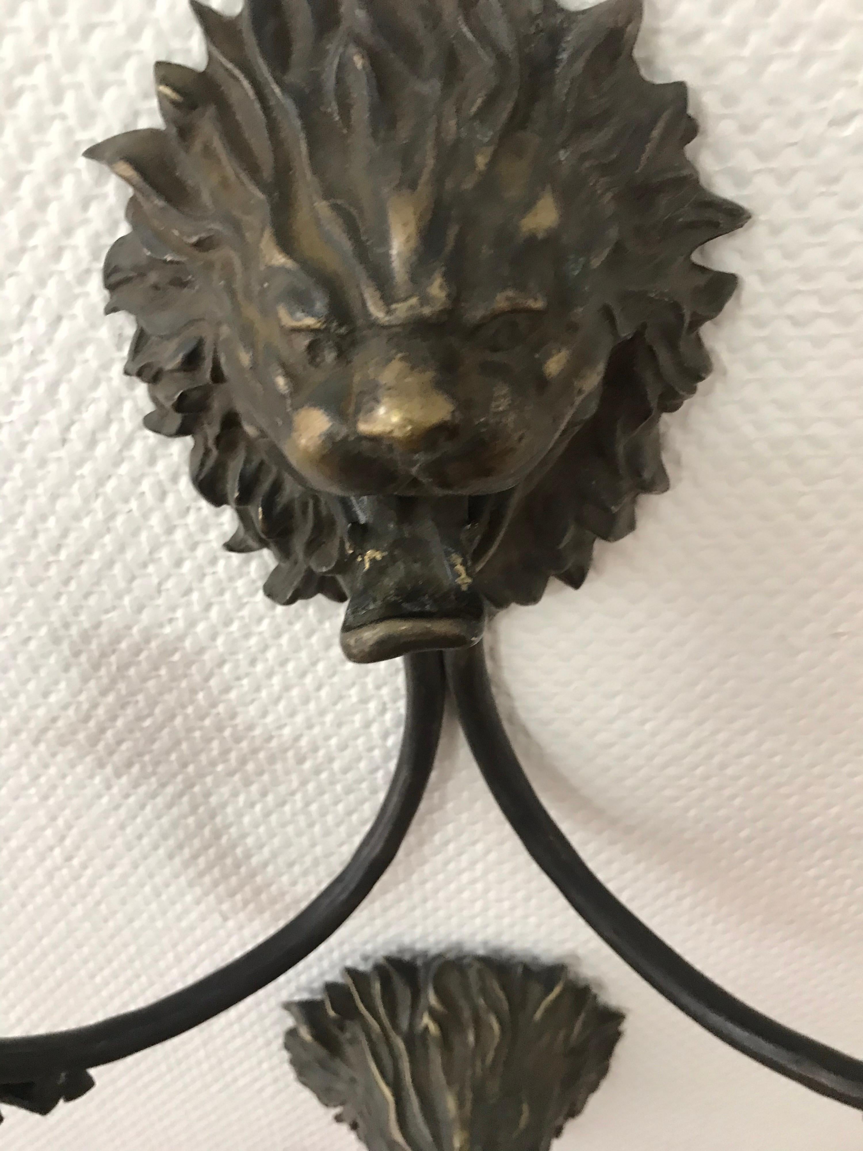 This is a pair of heavy metal or bronze Lion candle sconces from mid to late 20th century.