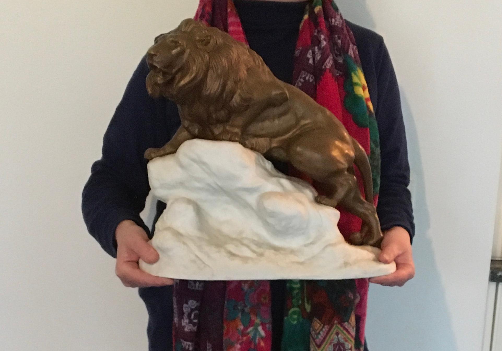 Bronze lion on a white rock - on top of the world like the Lion King. 
A stunning animal sculpture by Clovis Edmond Masson, a French artist known for animal sculptures ( 1838 - 1913 ) 
Very detailled gilt bronze lion animal on a white bisquit -