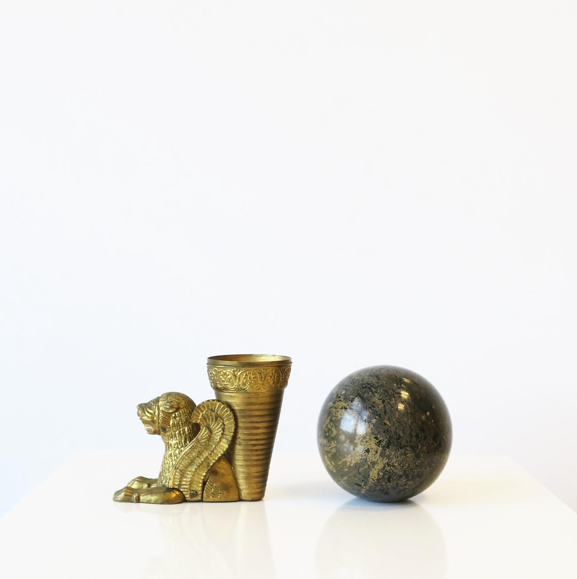 A substantial bronze gold-gilt lion vase or decorative object sculpture in the Egyptian Revival style, circa 20th century or earlier. Beautiful as a small vase with a lot of style, and also great as a standalone decorative object. Dimensions: 4.5