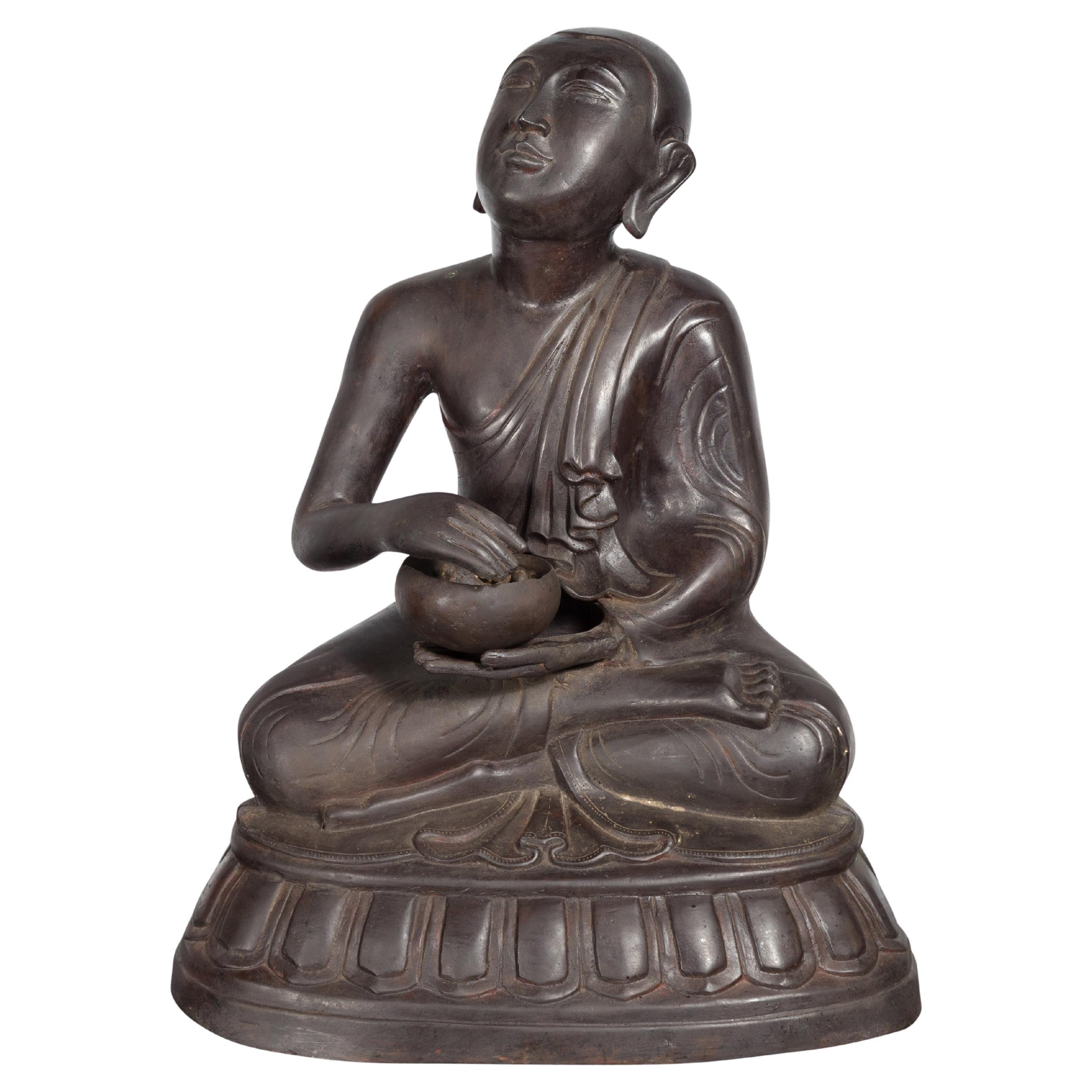 Bronze Lost Wax Sculpture Depicting a Praying Buddhist Monk with Offering Bowl