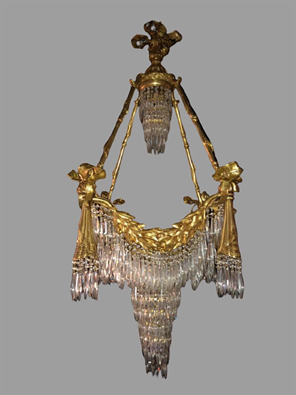 Bronze Louis XVI style crystal ribbon and tassel drapery chandelier with 18 lights. Newly wired. This fine custom quality chandelier is simply stunning and certain to light up any area of the home. The ribbon and tassel form doré bronze fixtures